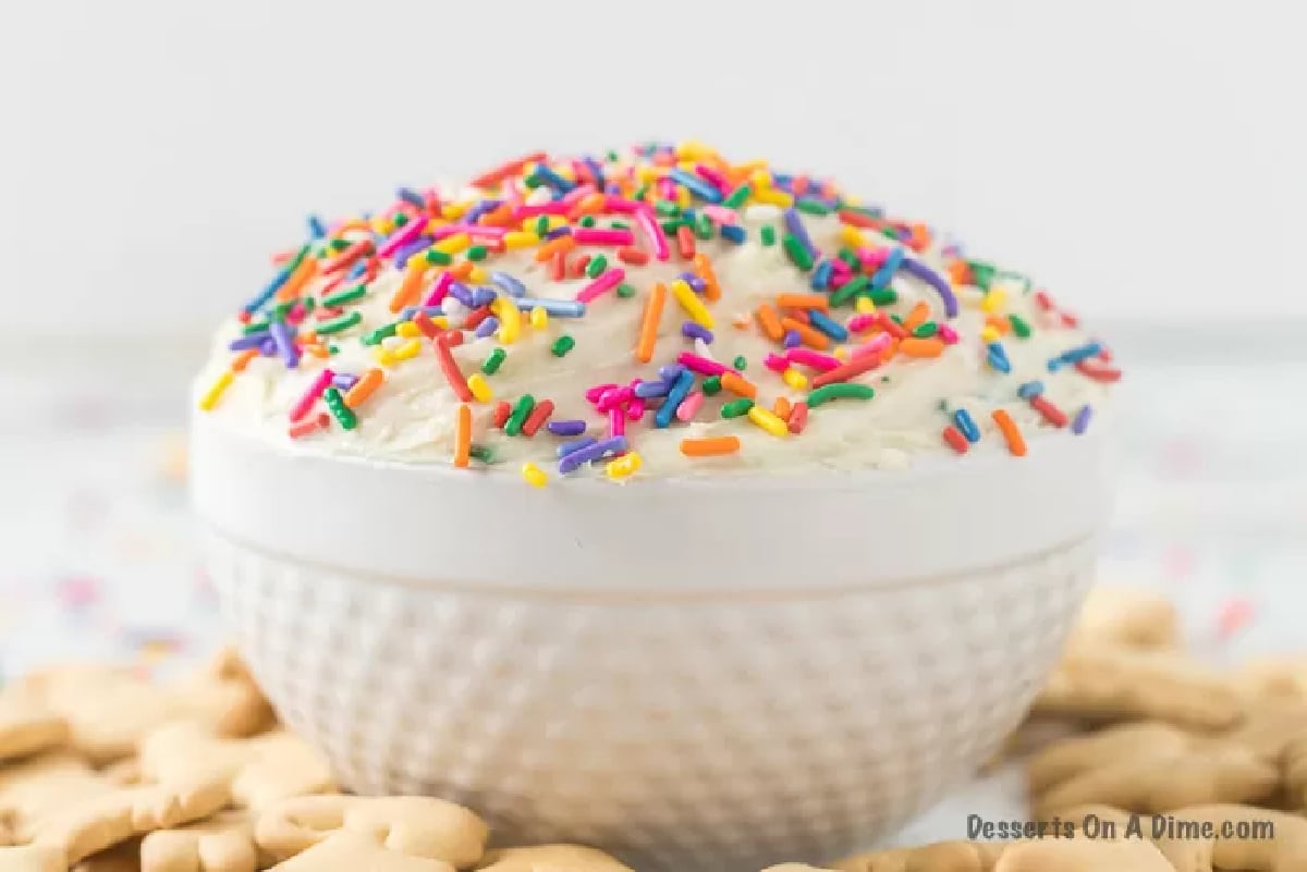 Cream Cheese Dessert Dip with sprinkles on top and animal crackers around it. 