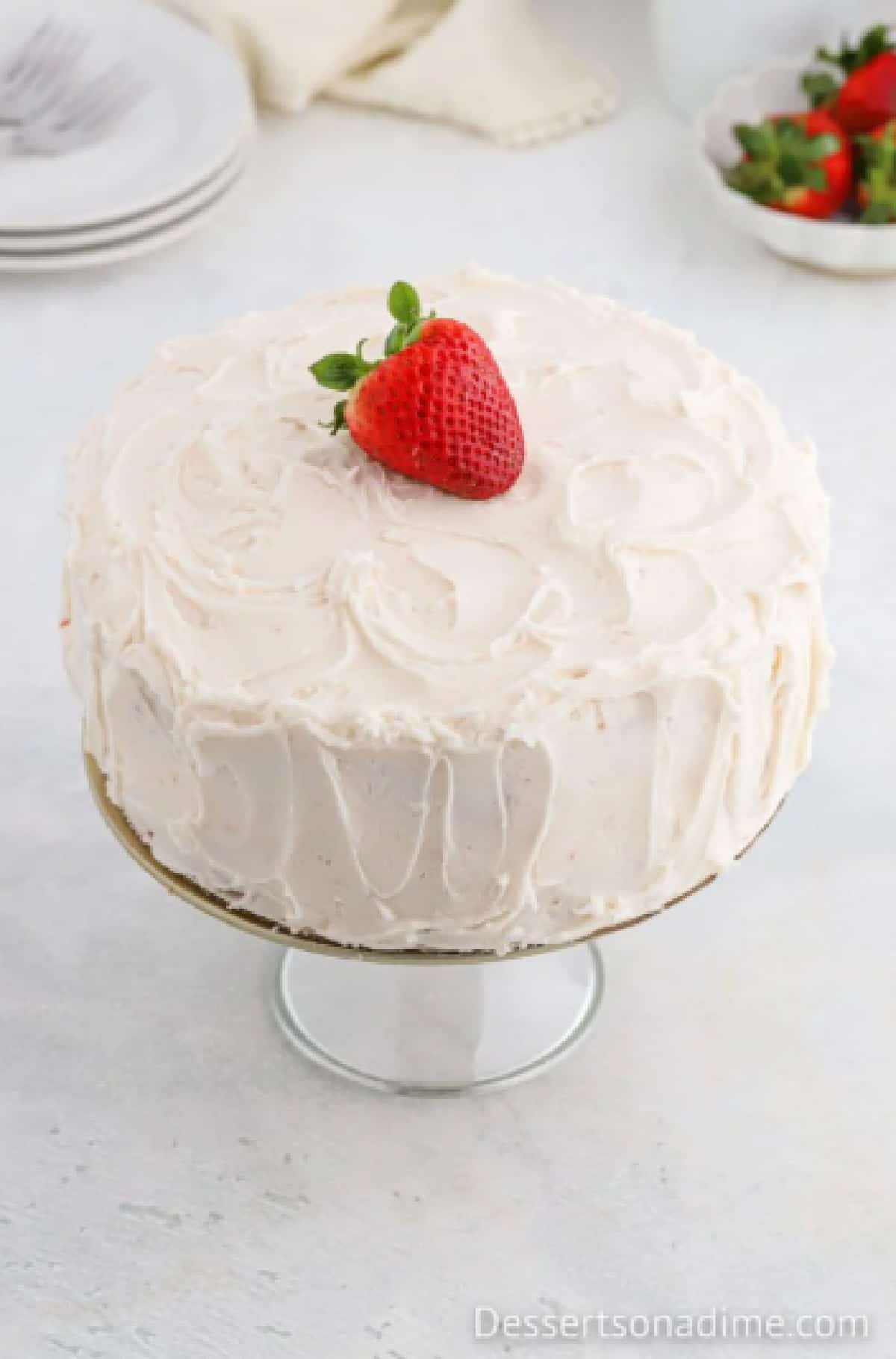 Cake topped with frosting and in between layers. 
