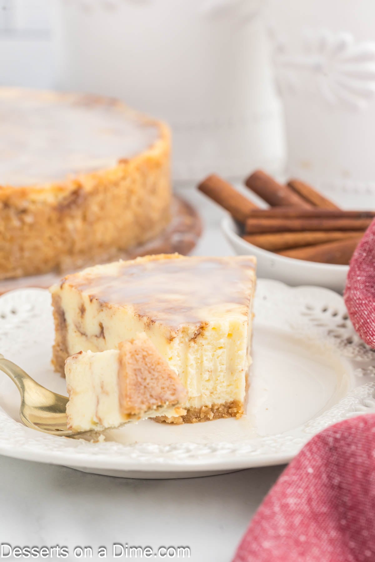 Honey Bun Cheesecake sliced and served on a plate. 
