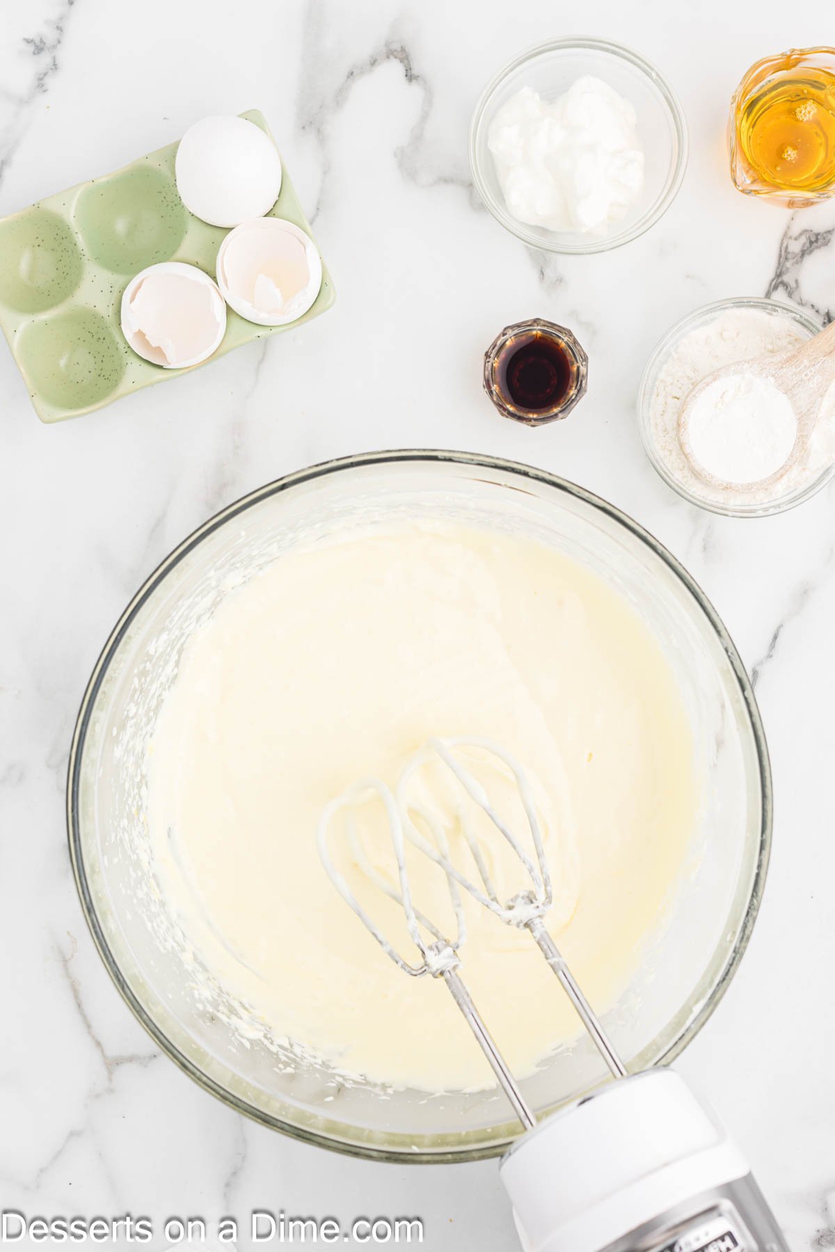 Eggs added to mixture one at a time. Then sour cream, honey, vanilla and flour mixed in. 