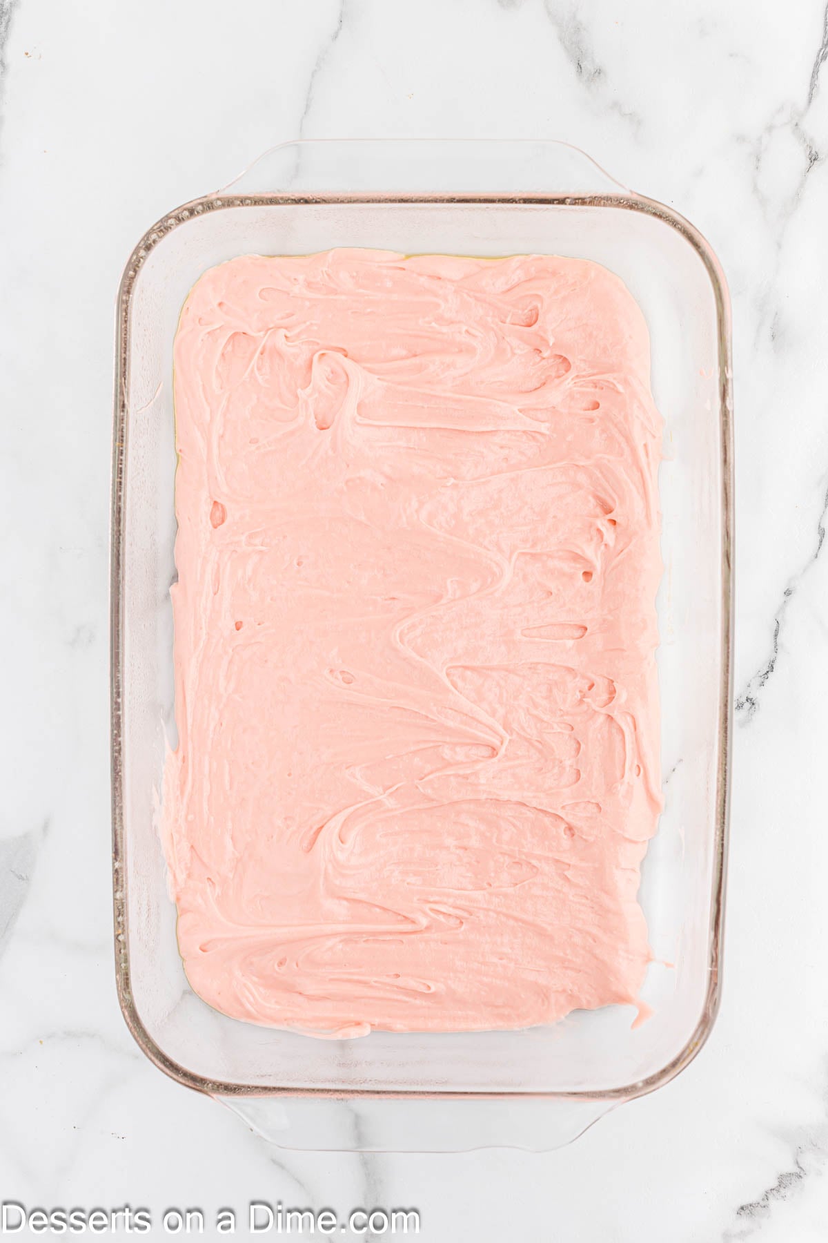 Strawberry batter spread into pan. 