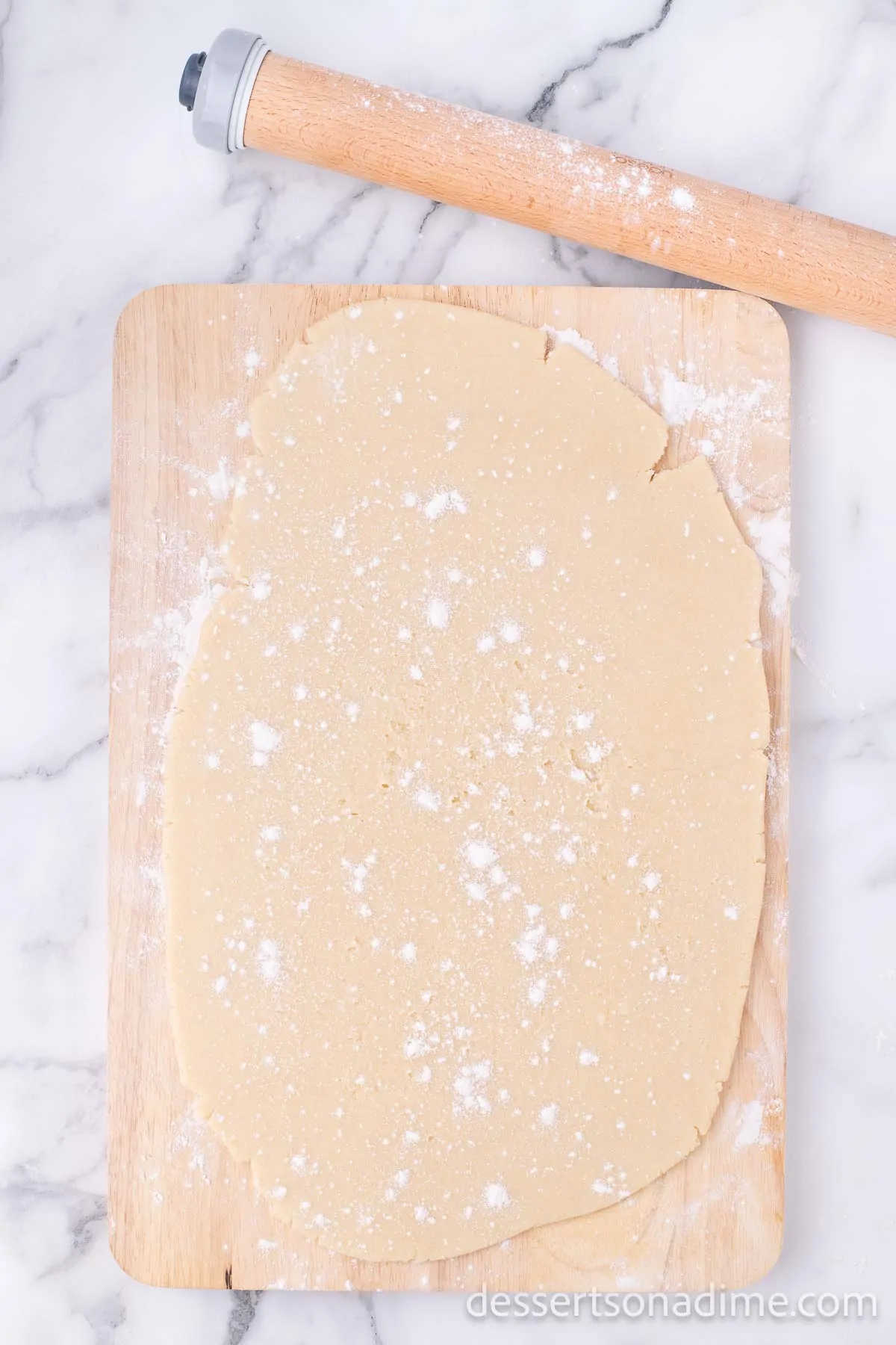 Dough rolled out and topped with flour.