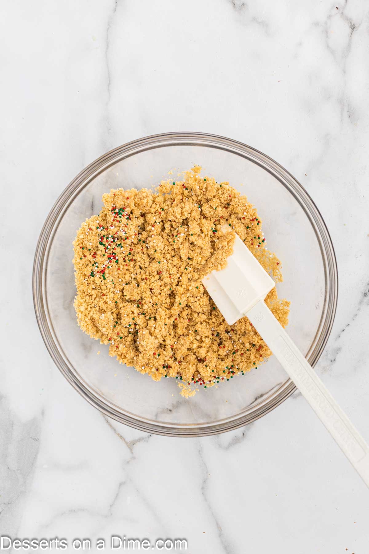 Oreo crumbs combined with butter in a bowl. 