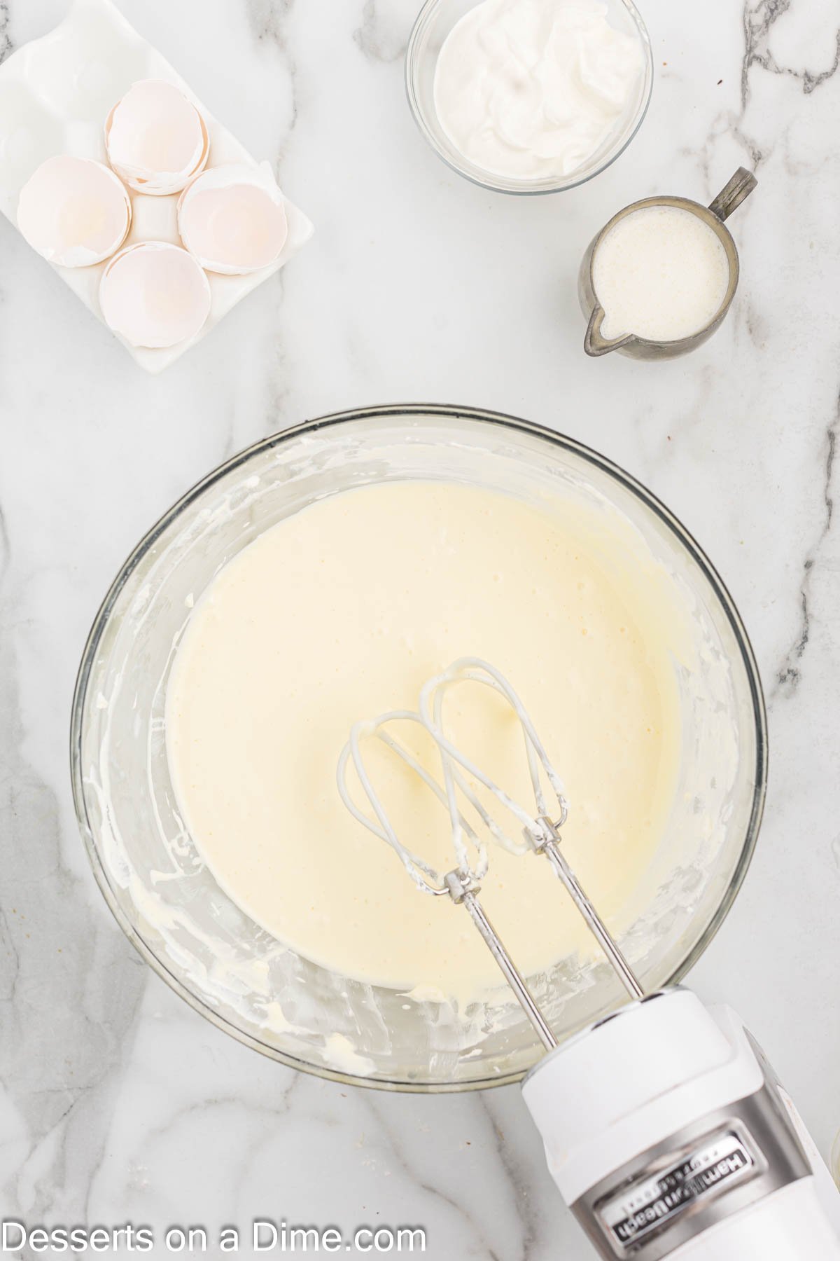 Eggs added into mixture one at a time and combined. 