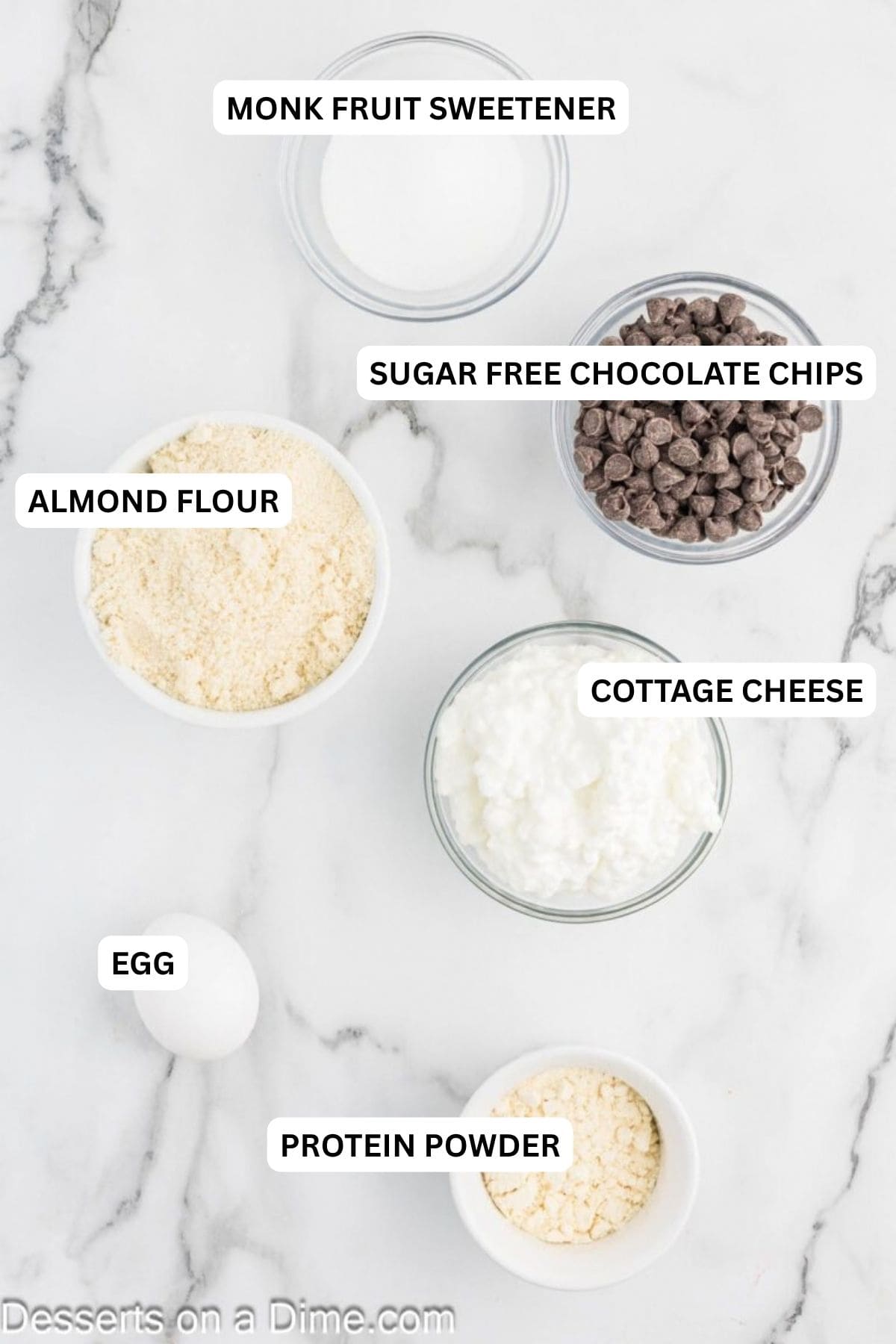 Ingredients for recipe - cottage cheese, egg, monk fruit sweetener, almond flour, protein powder and chocolate chips.