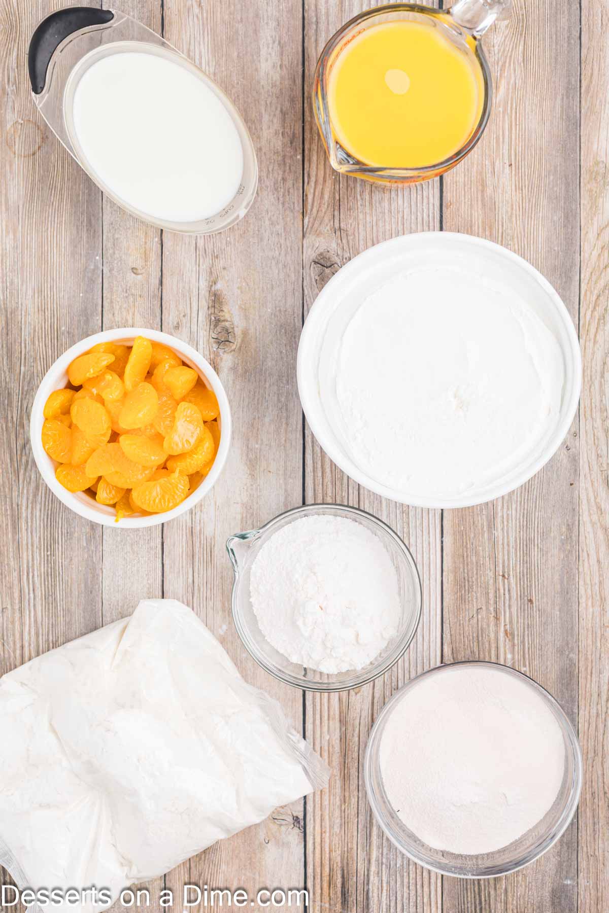 Ingredients for recipe - white cake mix, orange juice, orange jello, vanilla pudding, milk, cool whip, mandarin oranges. 