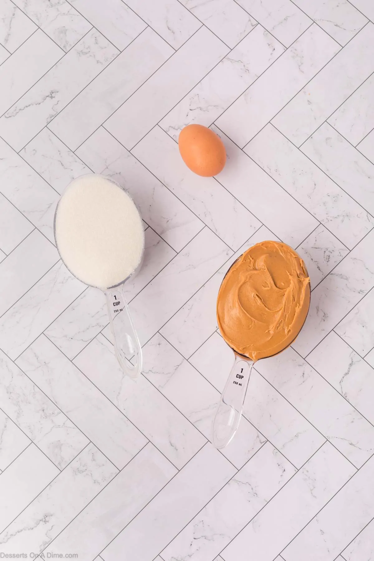 Ingredients for cookies - peanut butter, egg, sugar.