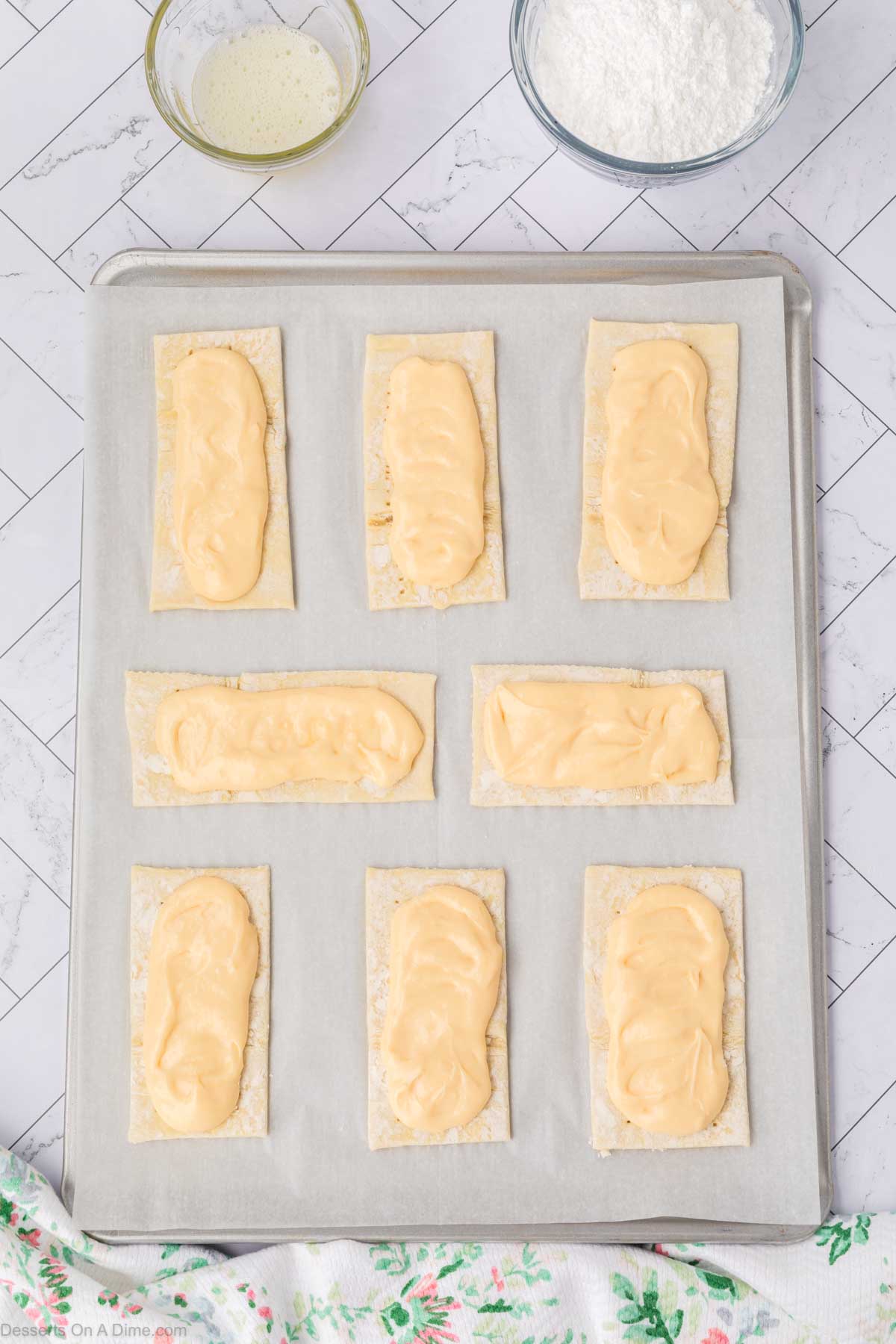 Cream cheese filling on baking sheet. 