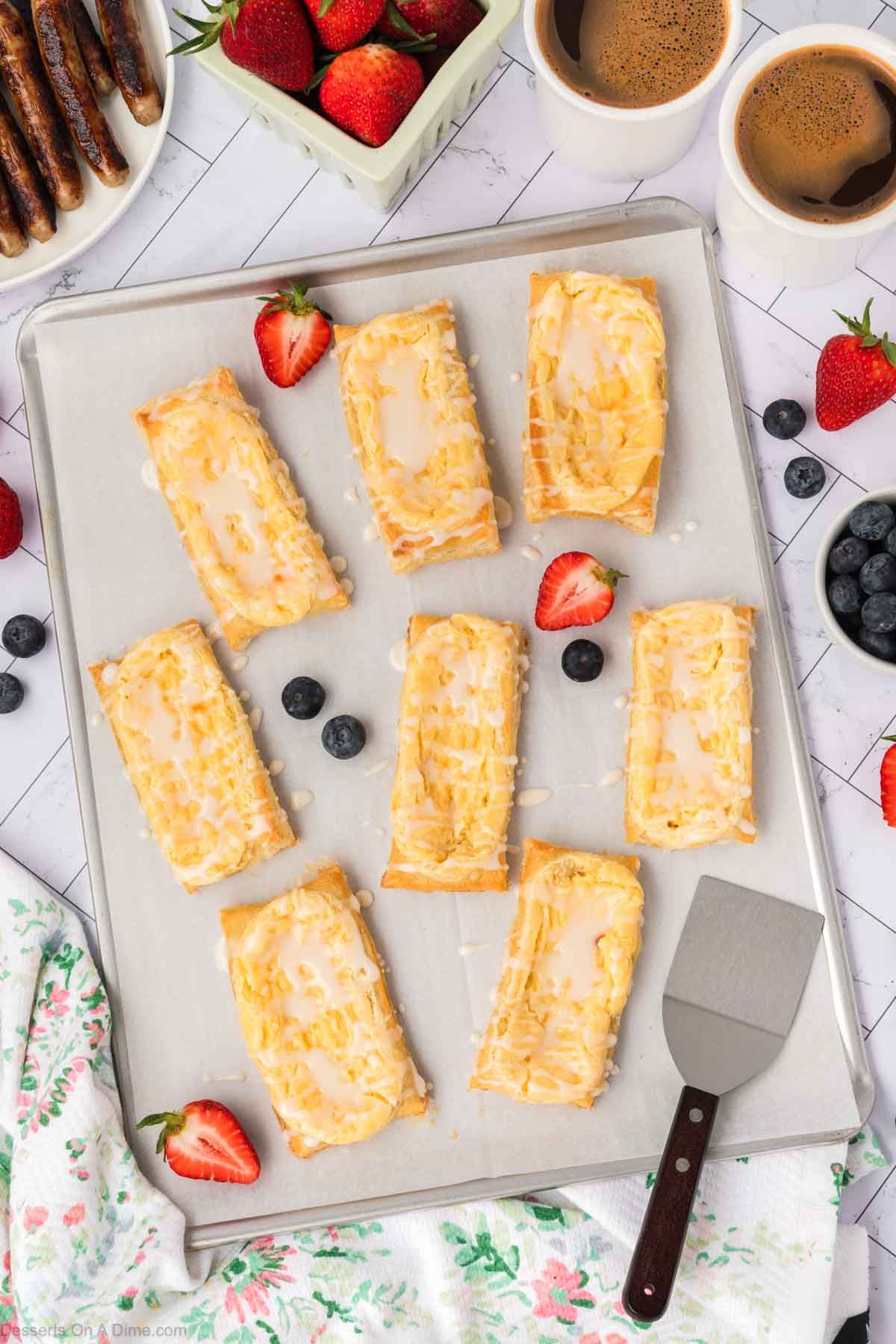Pastries with glaze on baking sheet. 