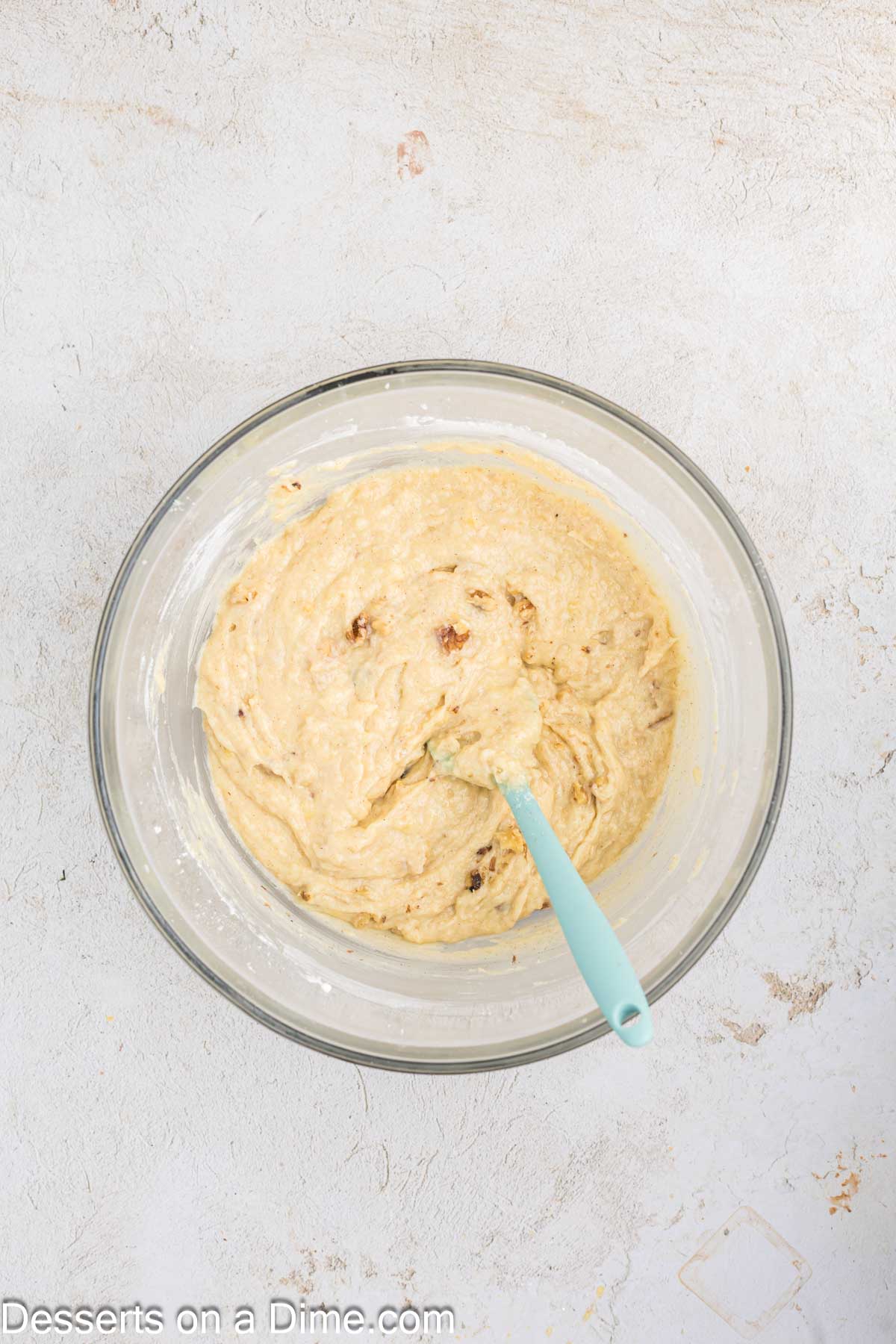 Dry ingredients folded into wet ingredients in a mixing bowl. 