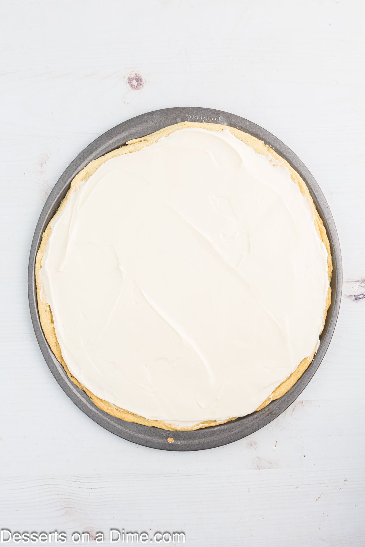 Frosting spread on cookie.