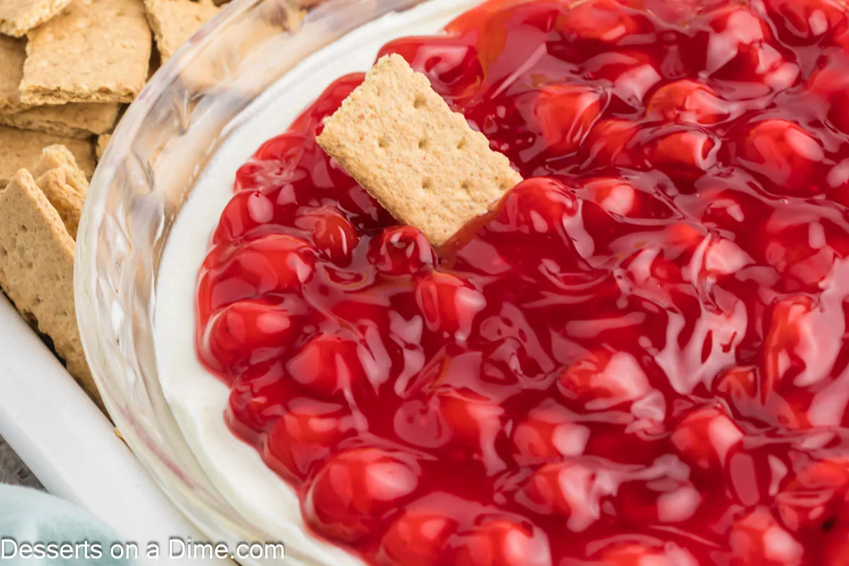 Cherry Cheesecake Dip in a dish with graham crackers.