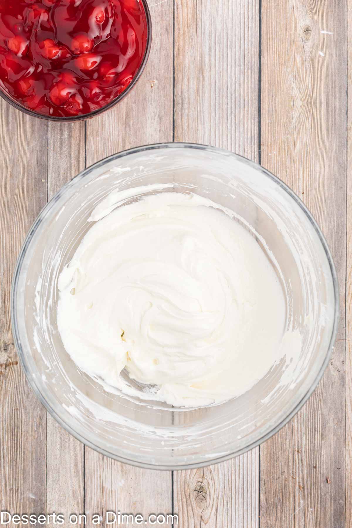 Whipped cream folded into bowl.