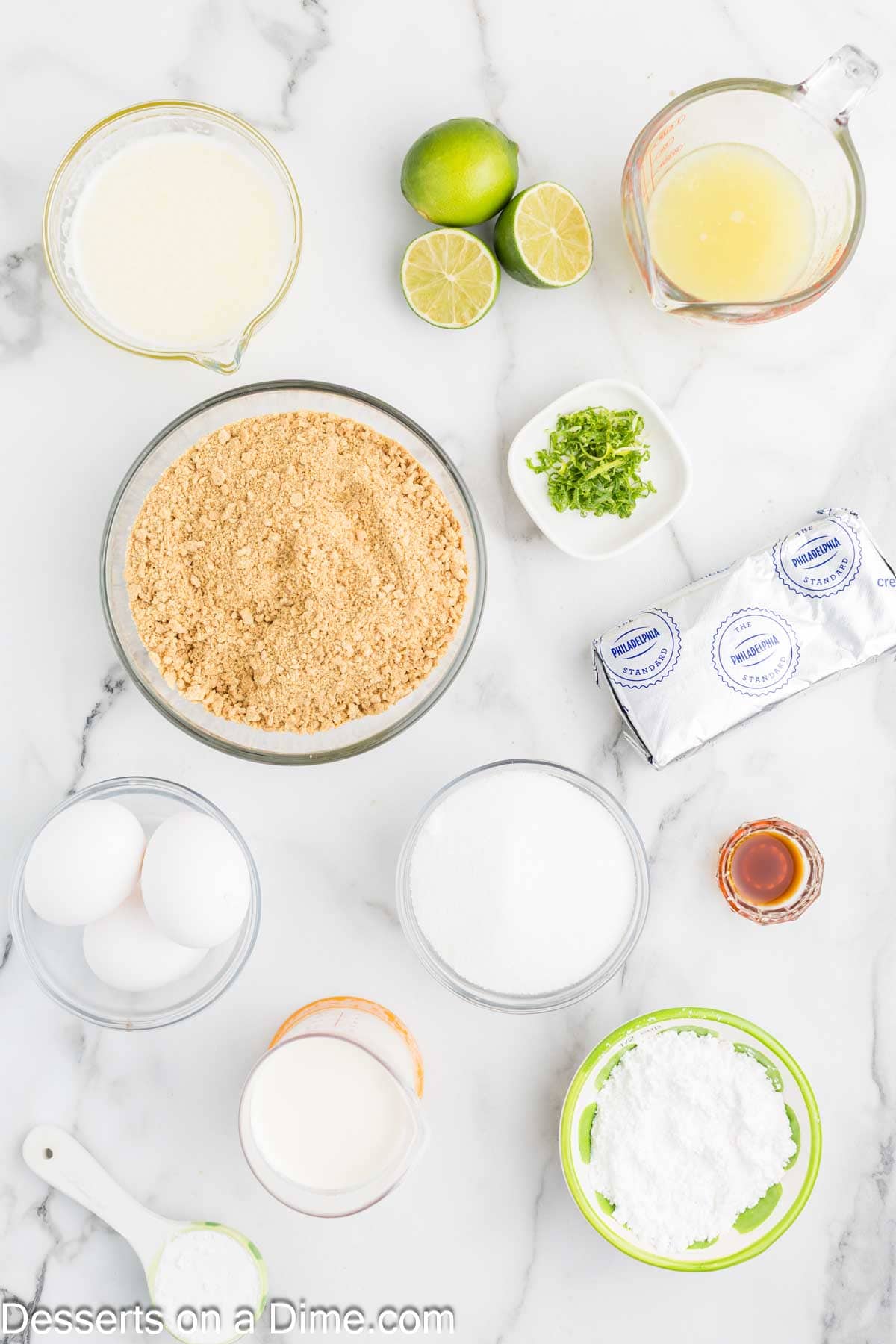 Ingredients for key lime cheesecake- graham cracker crumbs, sugar, butter, cream cheese, sugar, cornstarch, lime, heavy cream, powdered sugar, vanilla. 