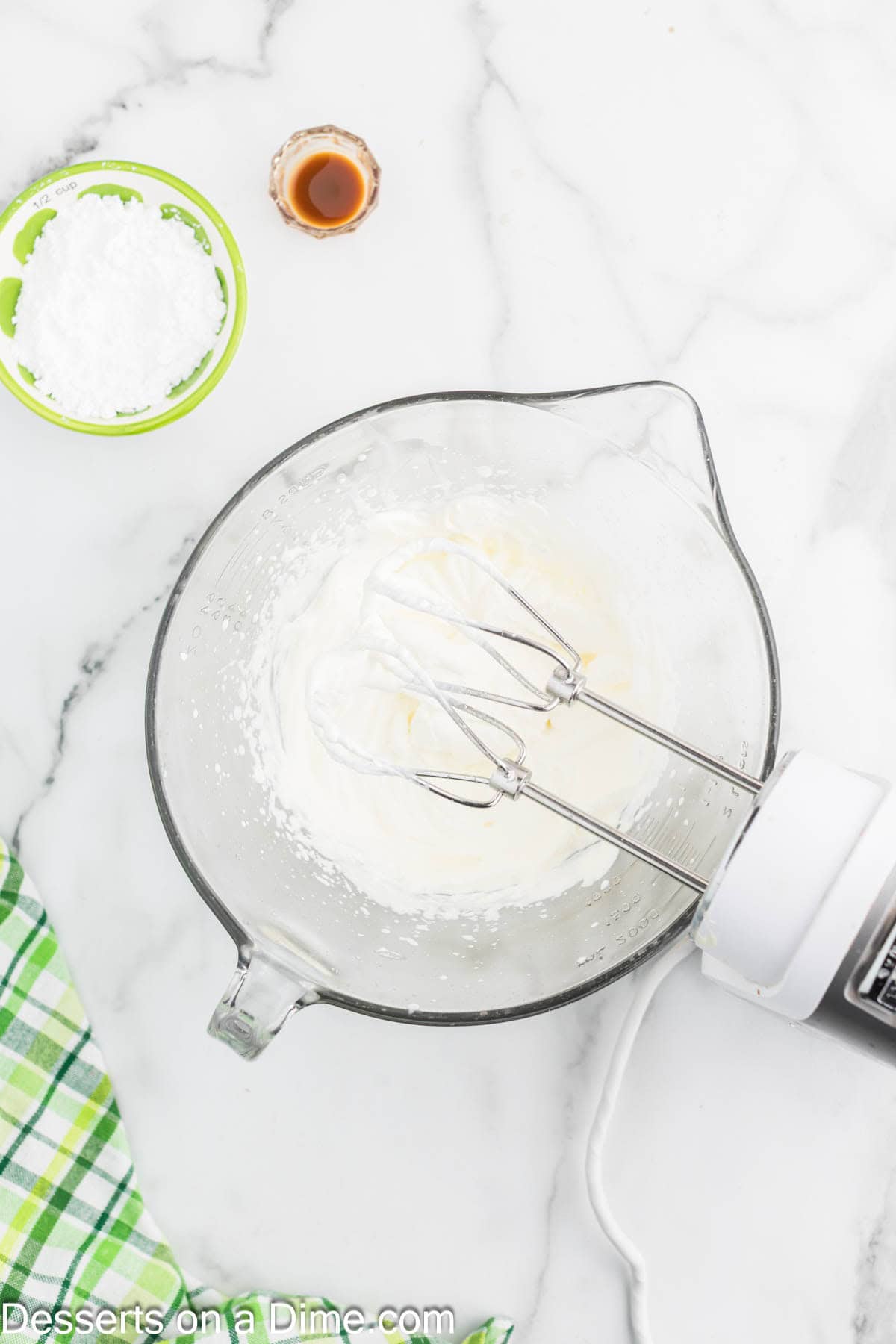 Whipped cream beat in mixing bowl. 