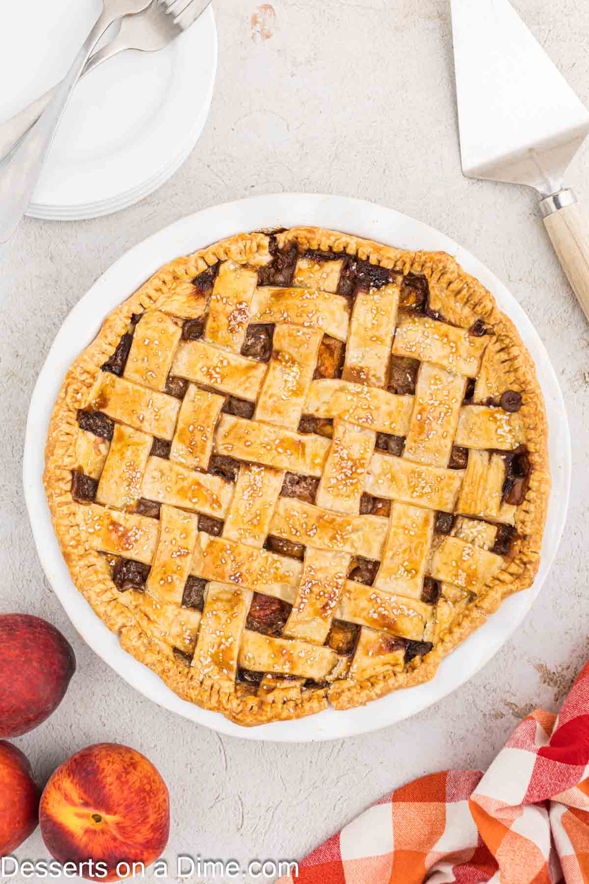 Pie baked until golden brown and cooling in white pie plate.
