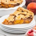A slice of peach pie on a plate.