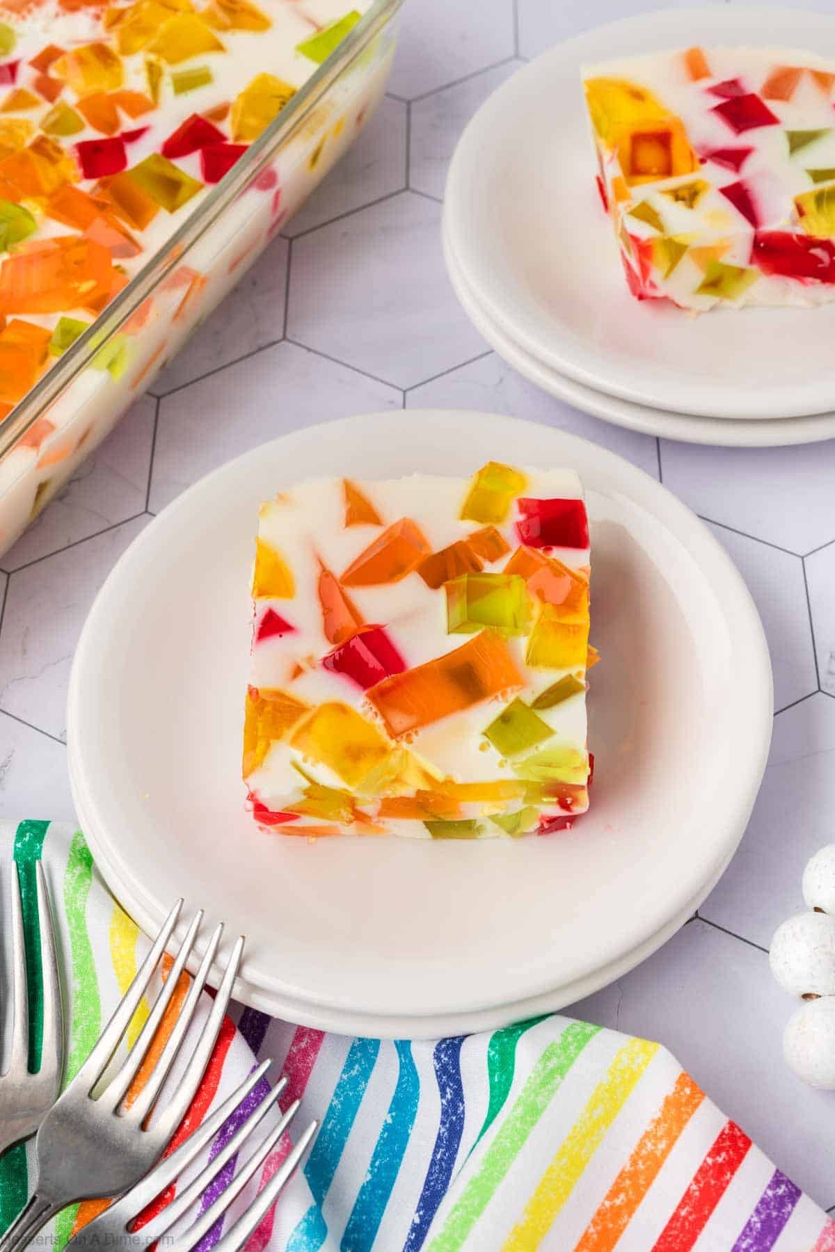 Slice of Broken Glass jello on white plate.
