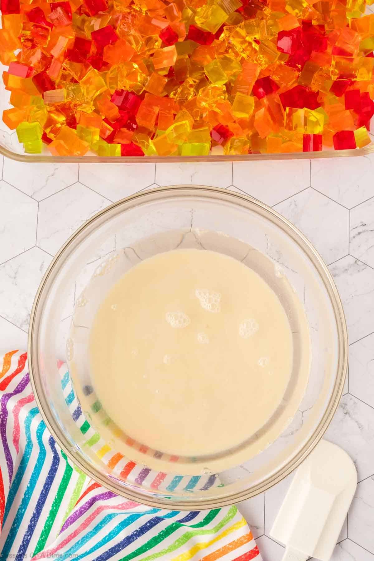 Sweetened condensed milk mixture combined in mixing bowl. 