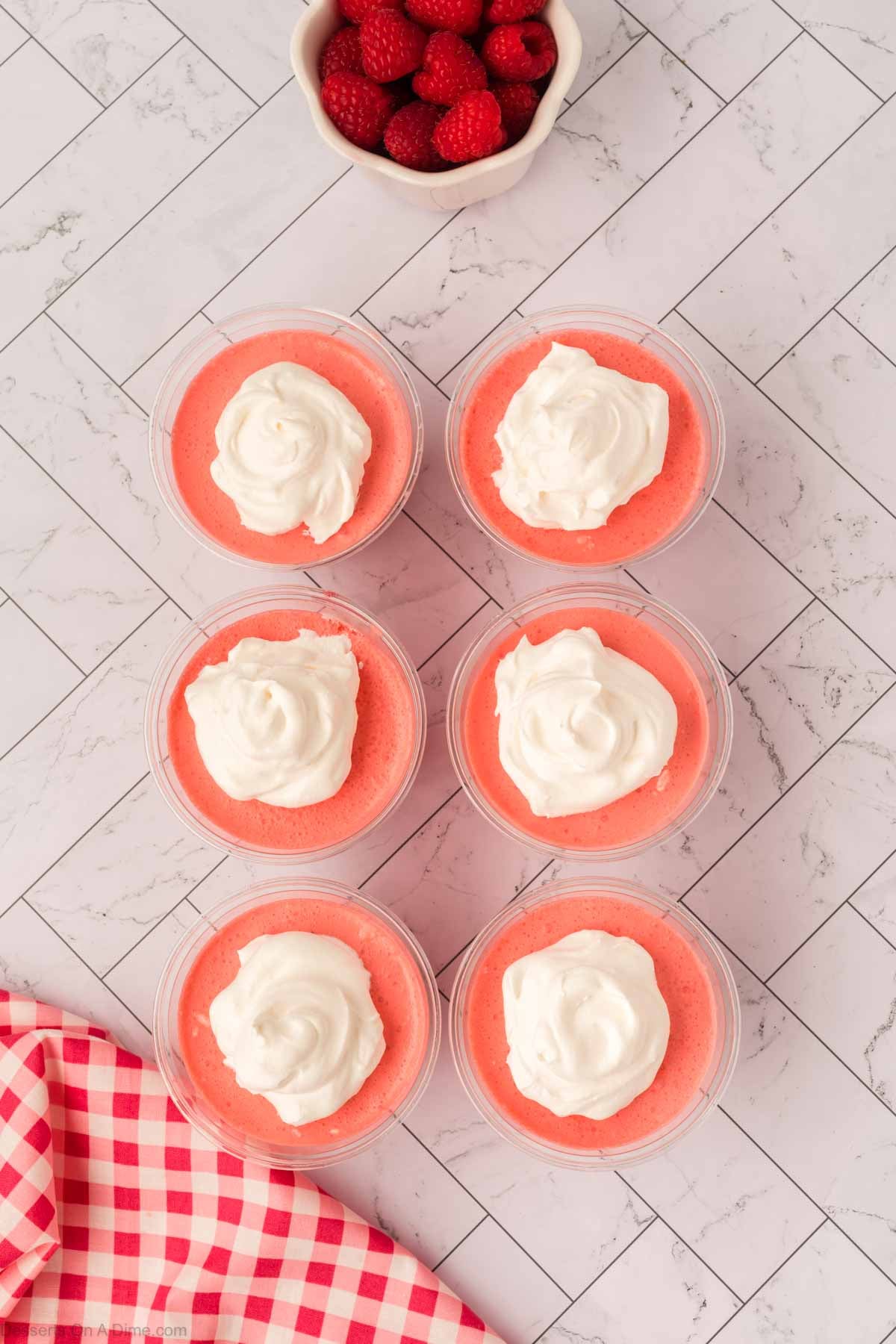 Whipped cream dolloped on each cup.