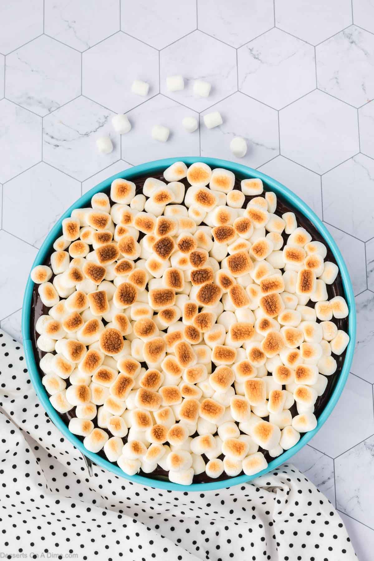 Mini marshmallows broiled on top of cheesecake. 