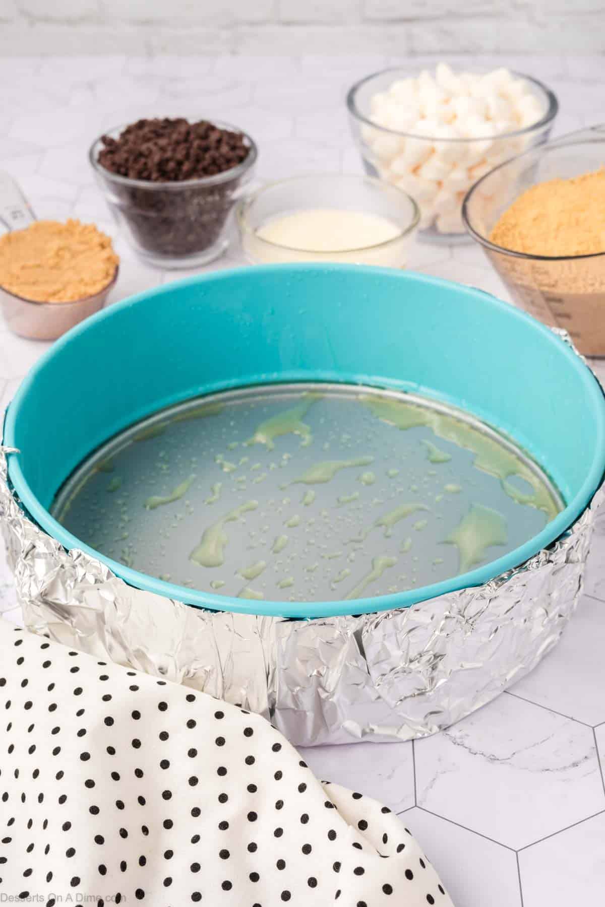 Springform pan with foil on the outside.