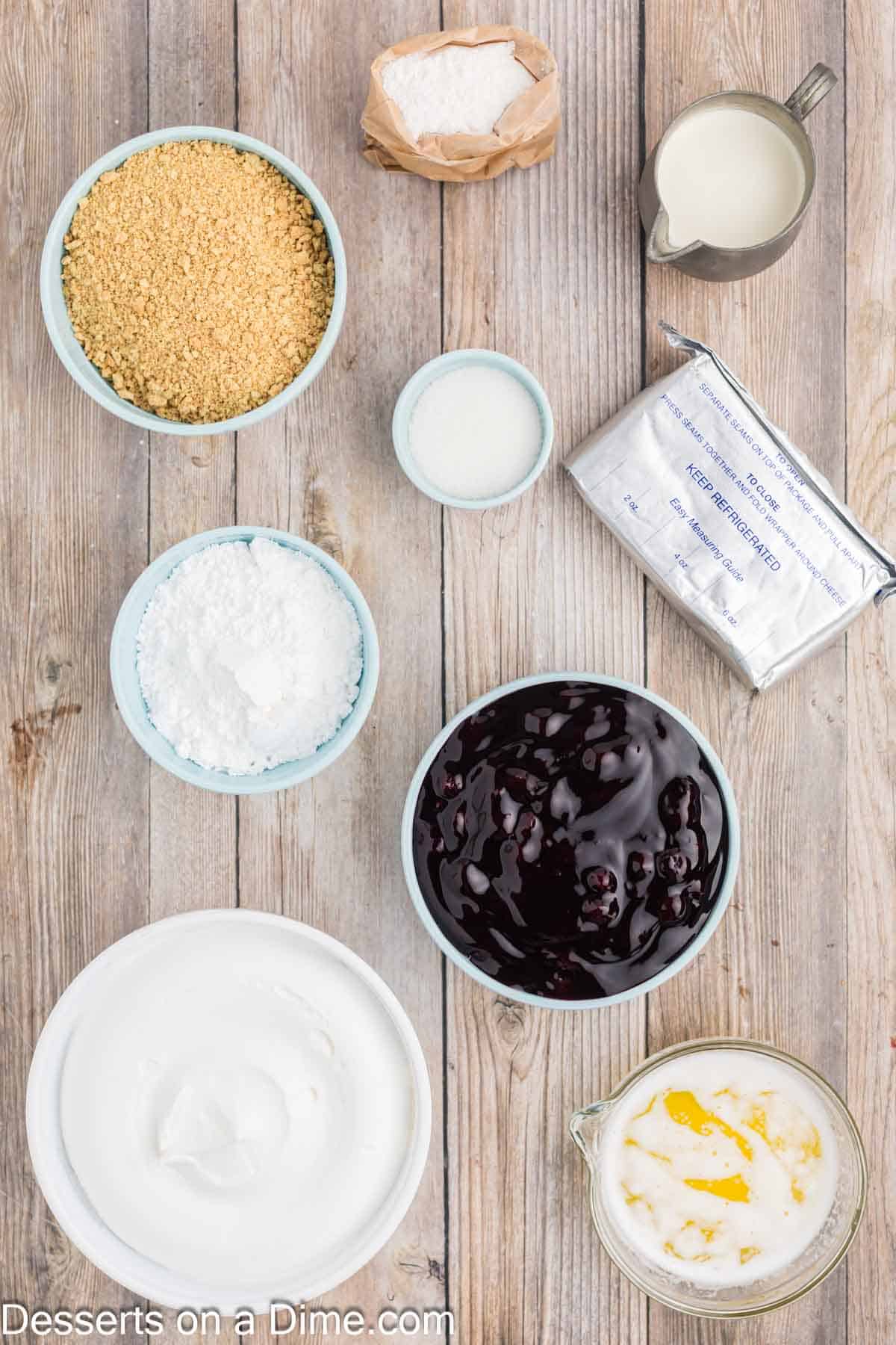 Ingredients for Lemon Blueberry Dessert - graham cracker crumbs, sugar, butter, lemon pudding, half and half, whipped cream, powdered sugar, blueberry pie filling.