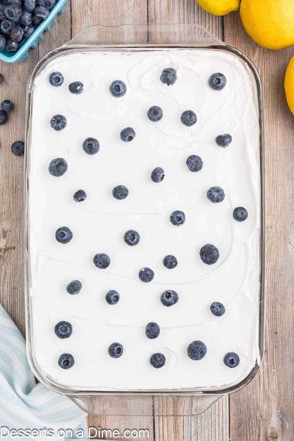 Whipped cream spread on top and fresh blueberries sprinkled all over.