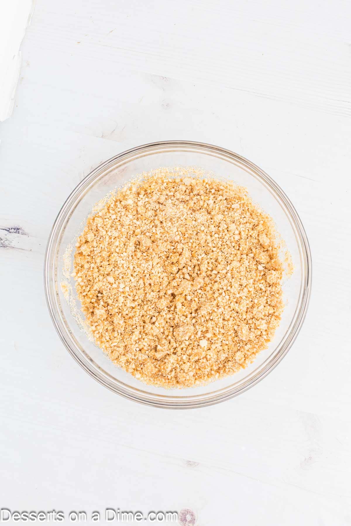 Crumbs in a bowl combined with butter and sugar.