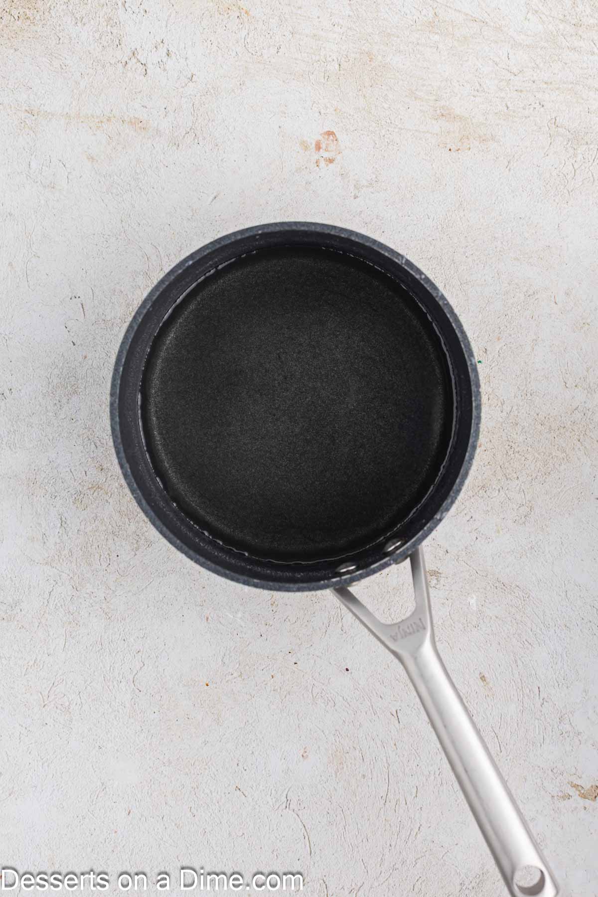 Saucepan with simply syrup mixture.