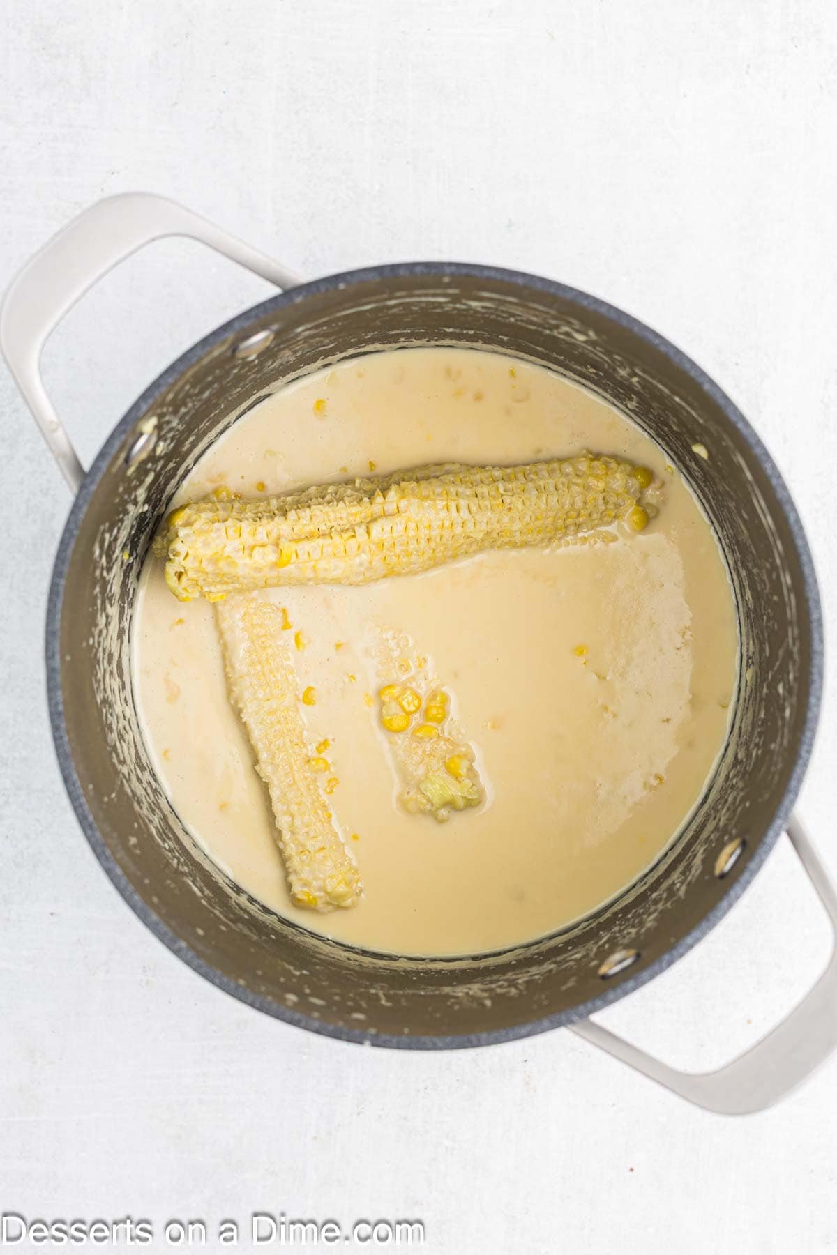 Corn on the cob in milk mixture.