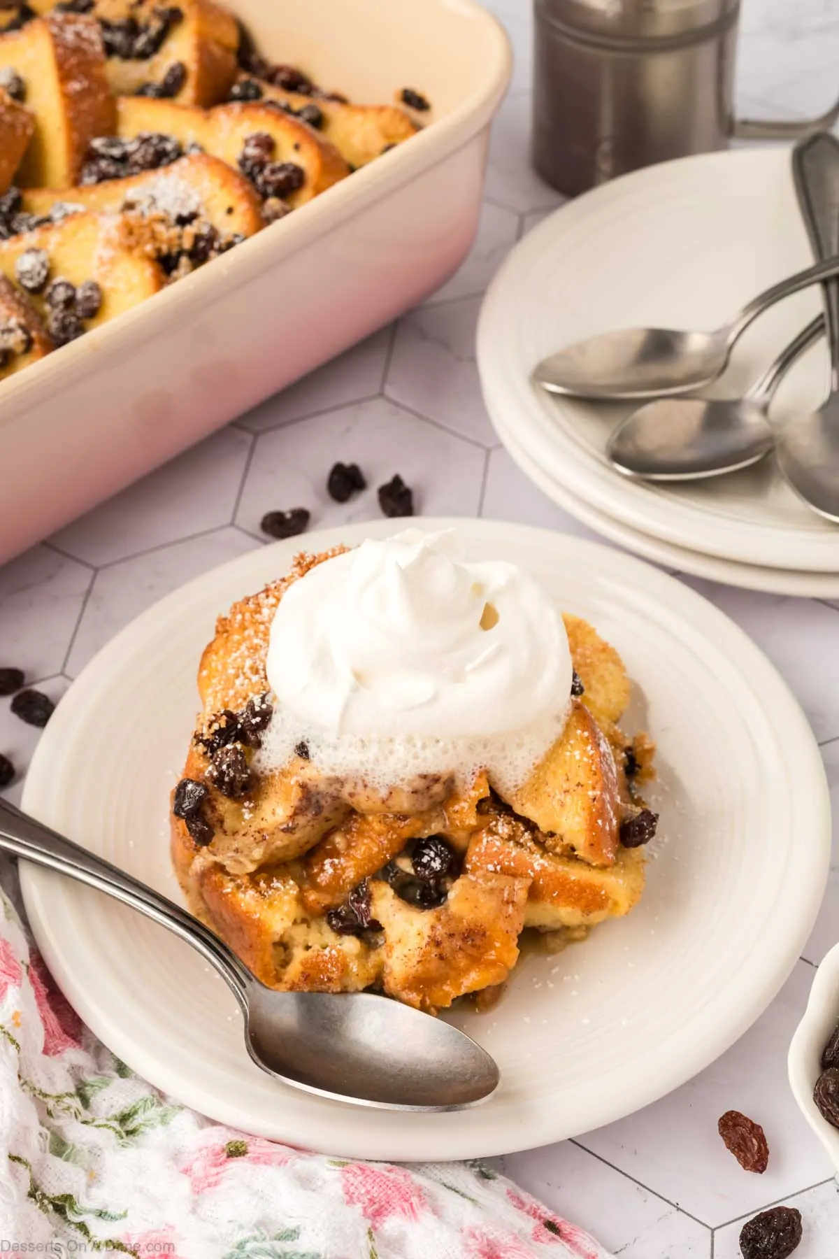 Bread and Butter pudding served on a white plate.