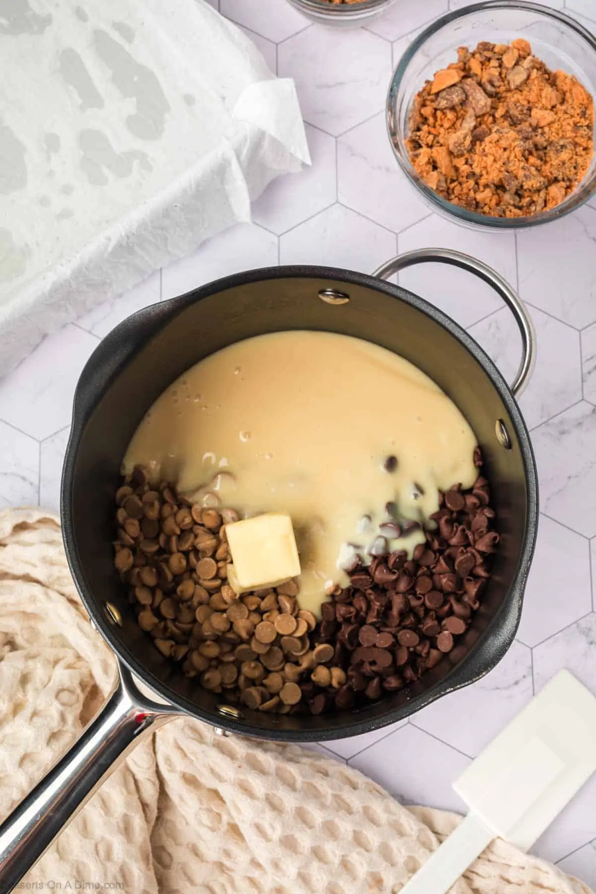 Chocolate chips and sweetened condensed milk combined in saucepan.