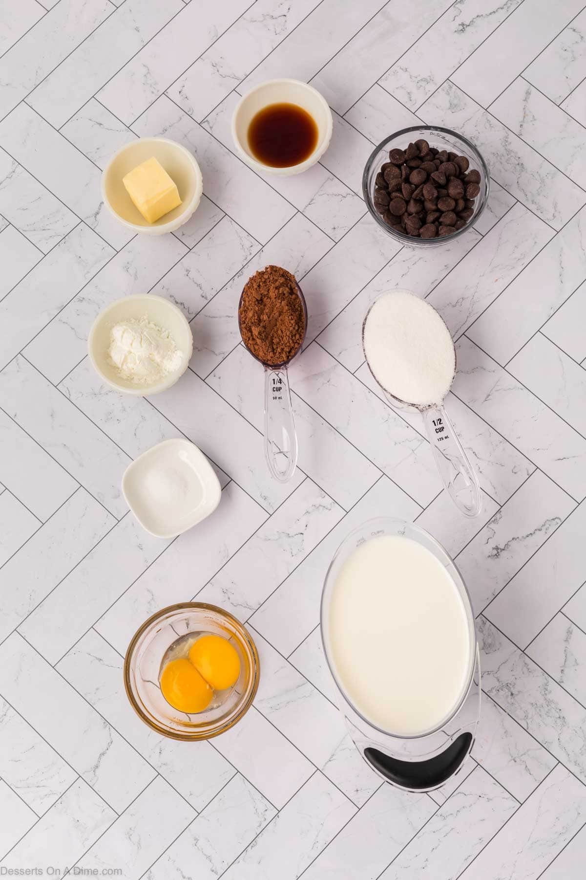 Ingredients for recipe - egg yolks, milk, sugar, cocoa powder, cornstarch, salt, vanilla, chocolate chips, butter.