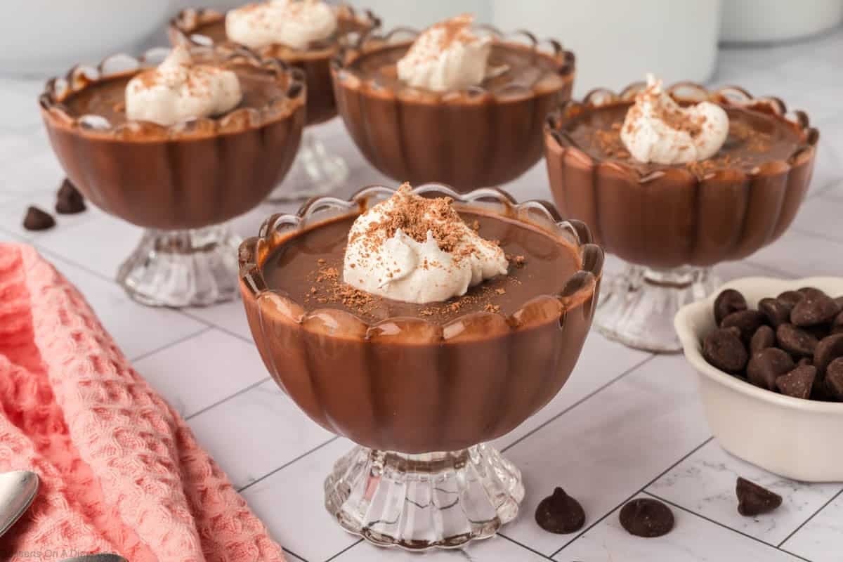Dark Chocolate pudding in cups with whipped cream.