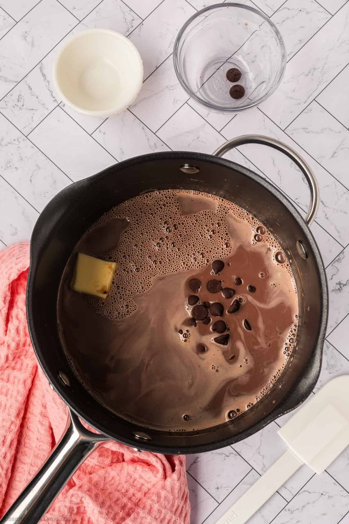 Butter and chocolate chips mixed into pan.