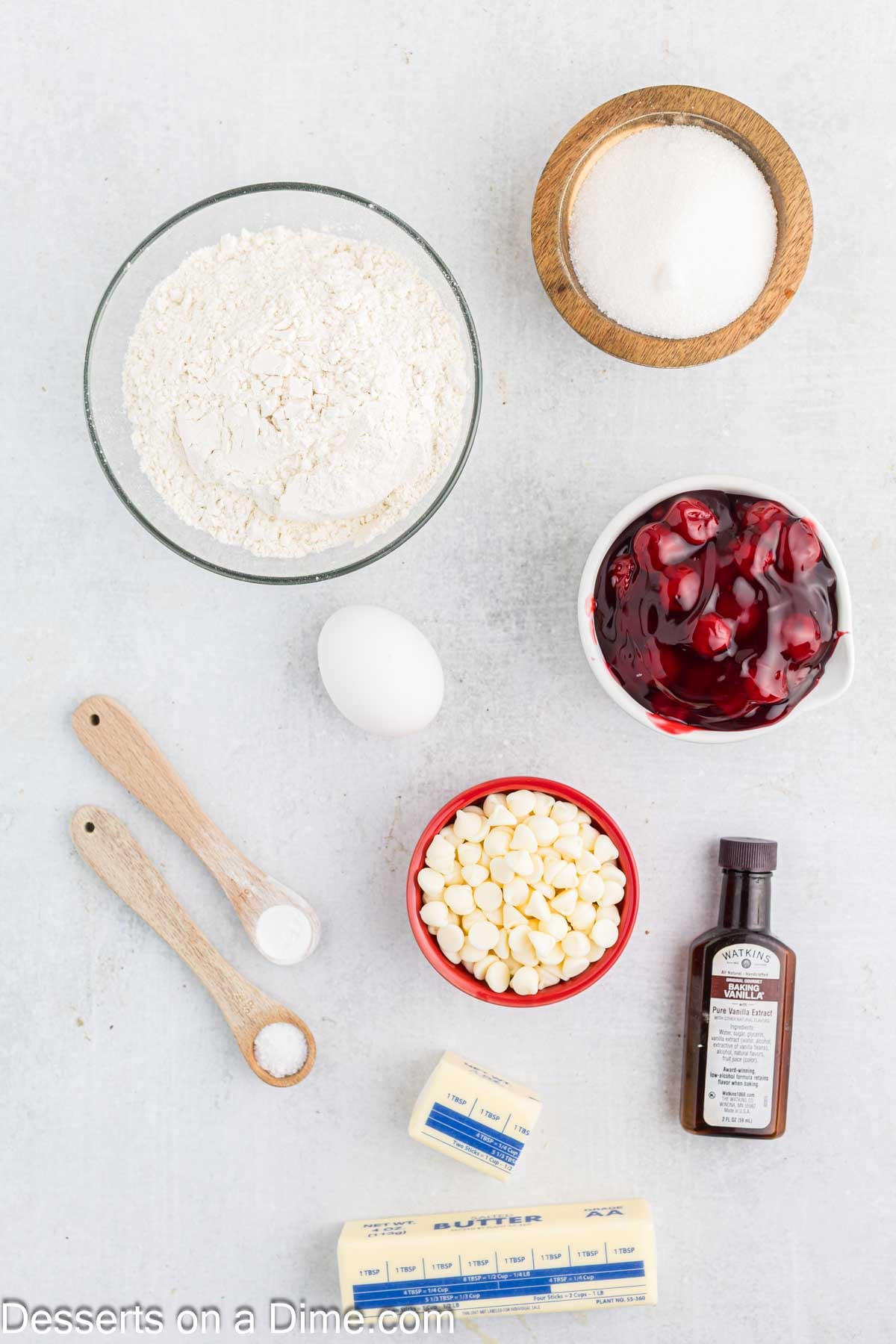 Ingredients for recipe - flour, baking powder, salt, butter, sugar, egg, vanilla, cherry pie filling, white chocolate chips. 