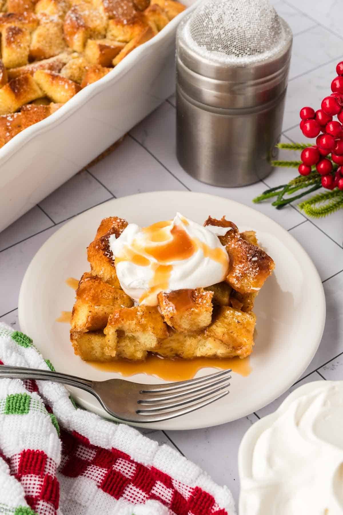 Serving of Eggnog Bread Pudding on a white plate. 