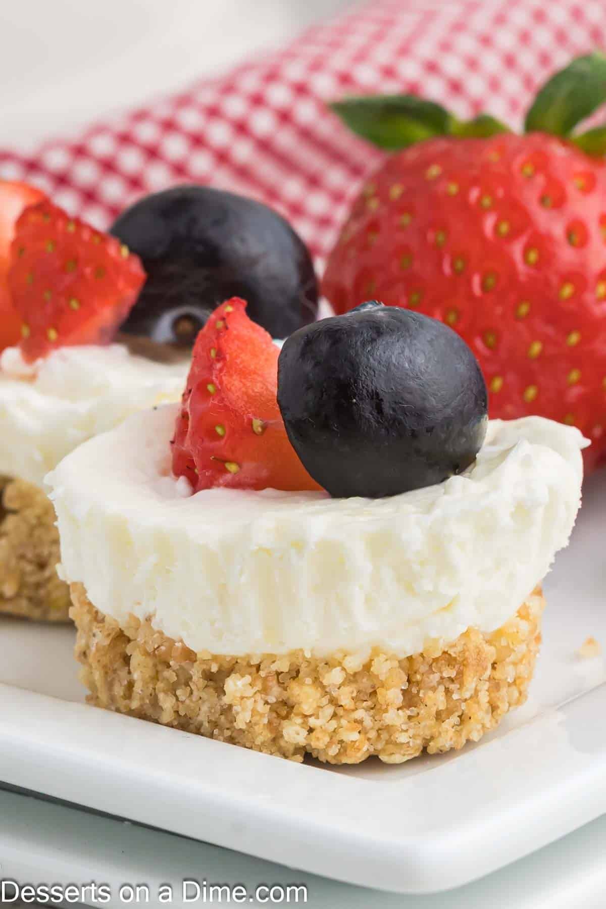 Mini Cheesecakes up close topped with berries. 