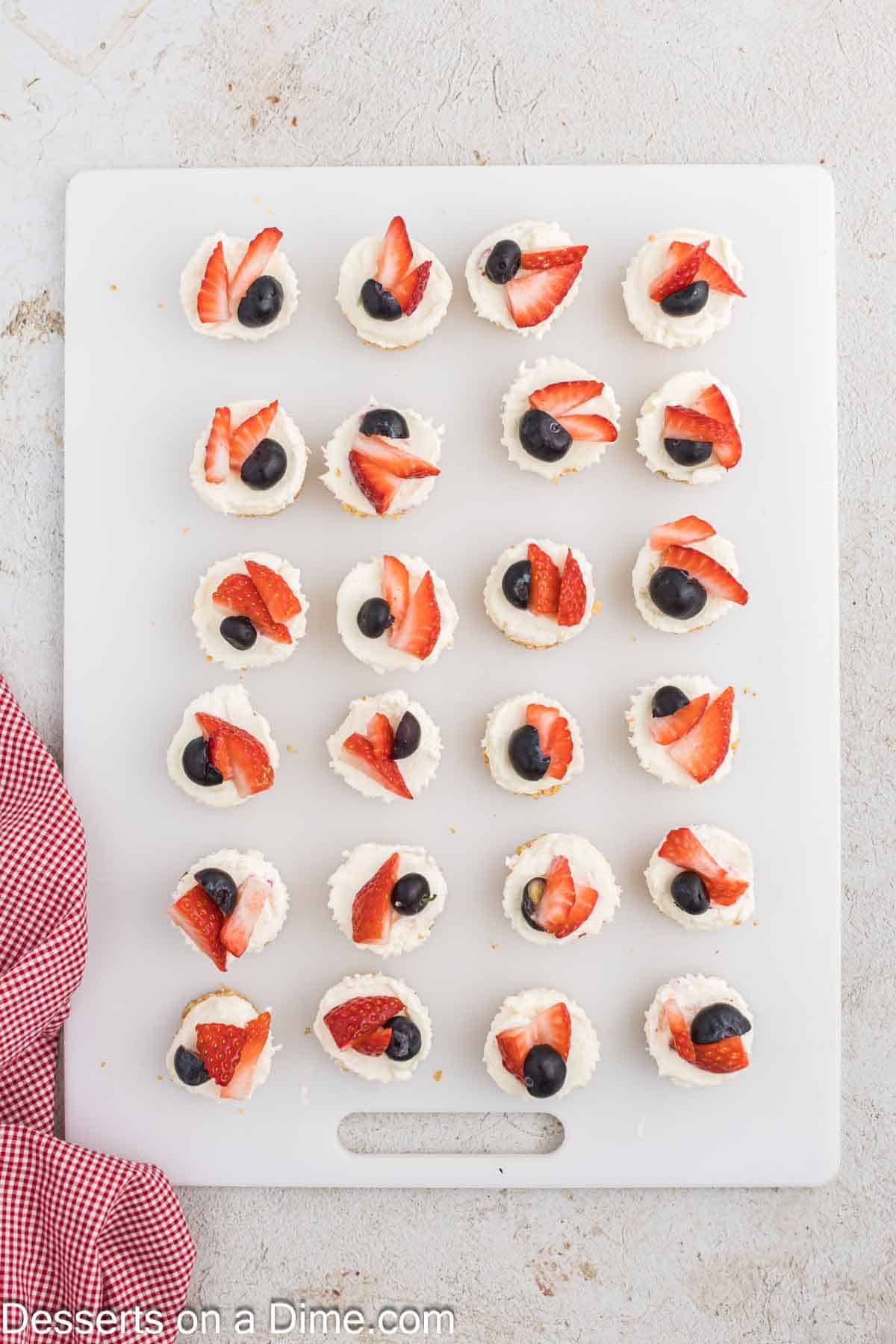 Berries on top of each mini cheesecake. 