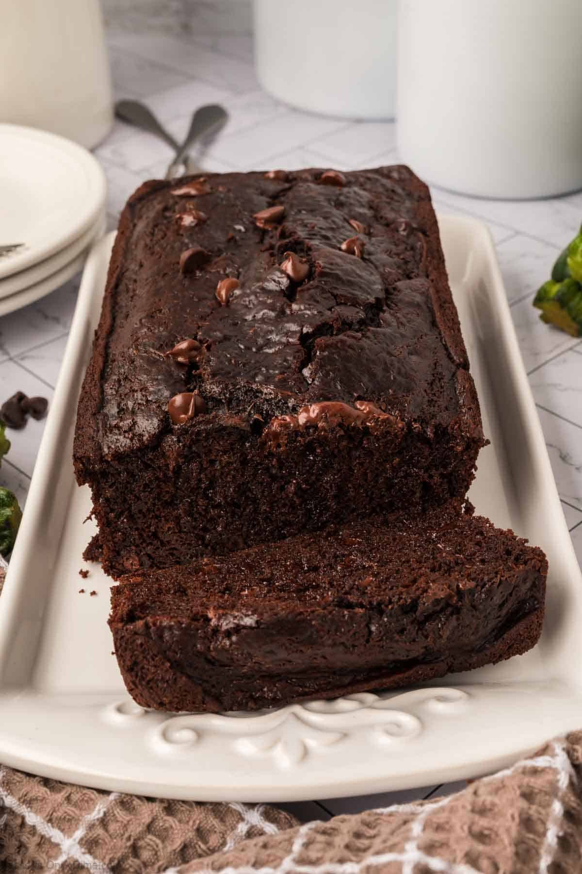 Chocolate zucchini bread being sliced.