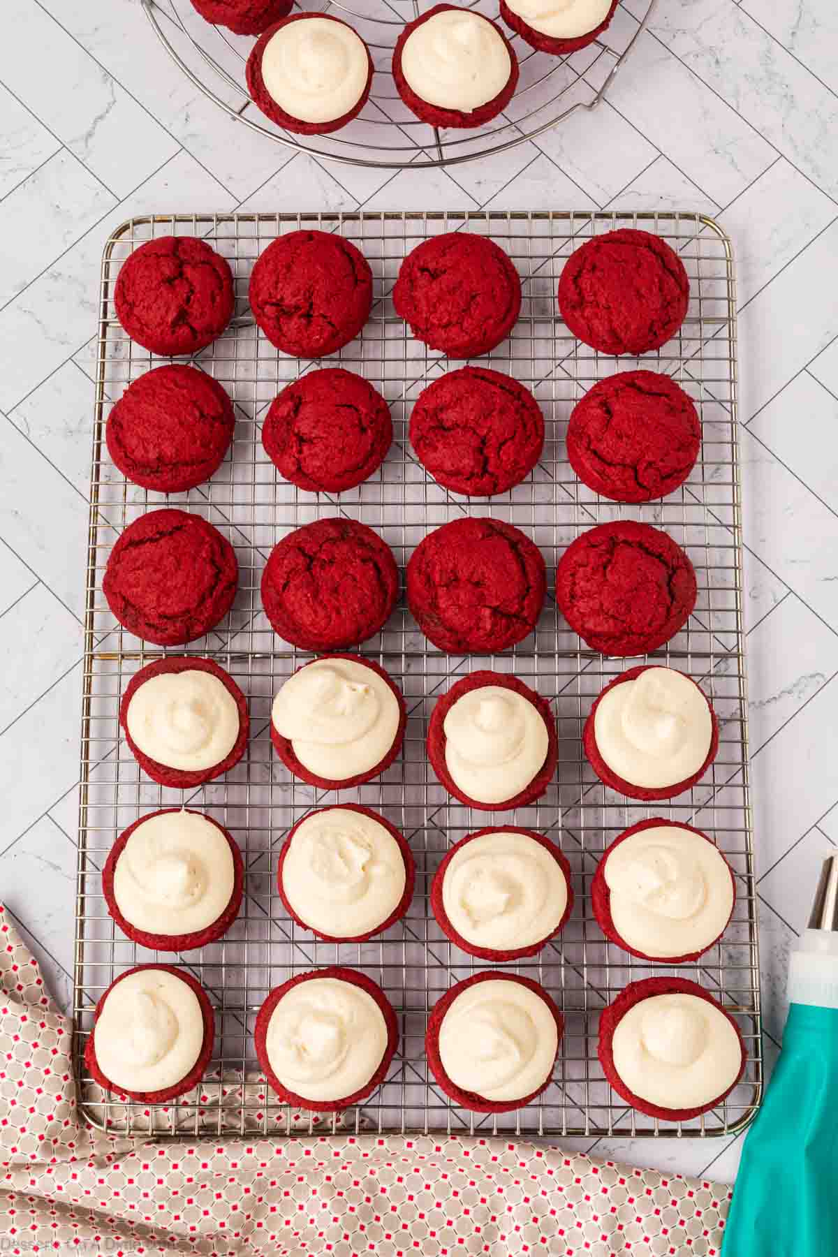 Frosting piped on to half of the cookies.