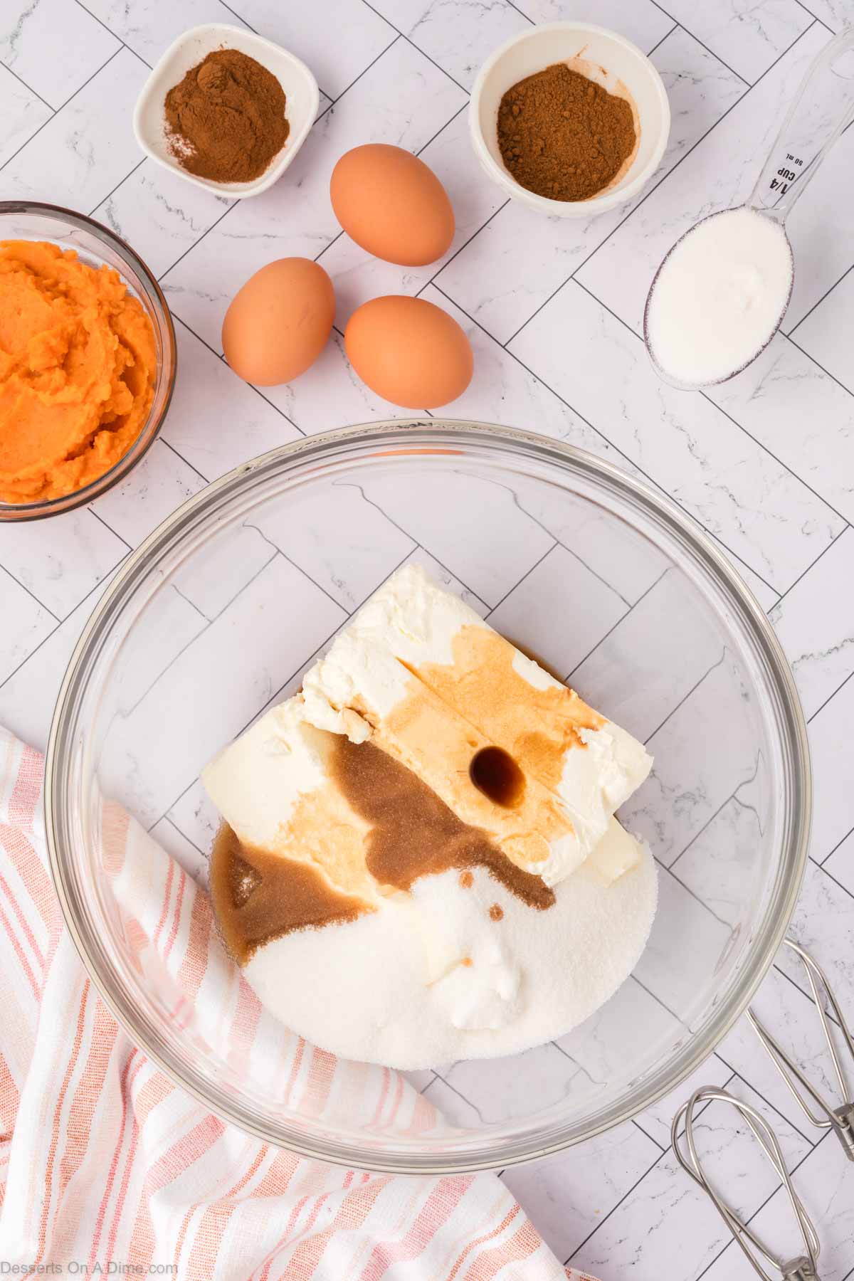 Cream cheese and sugar in a mixing bowl. 