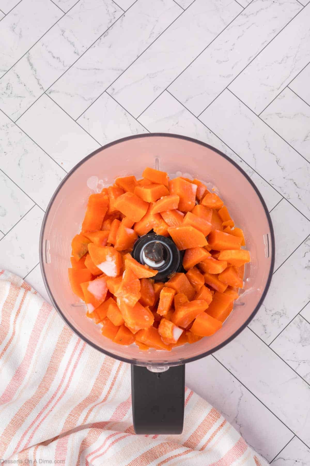 Diced sweet potatoes with milk in a food processor. 