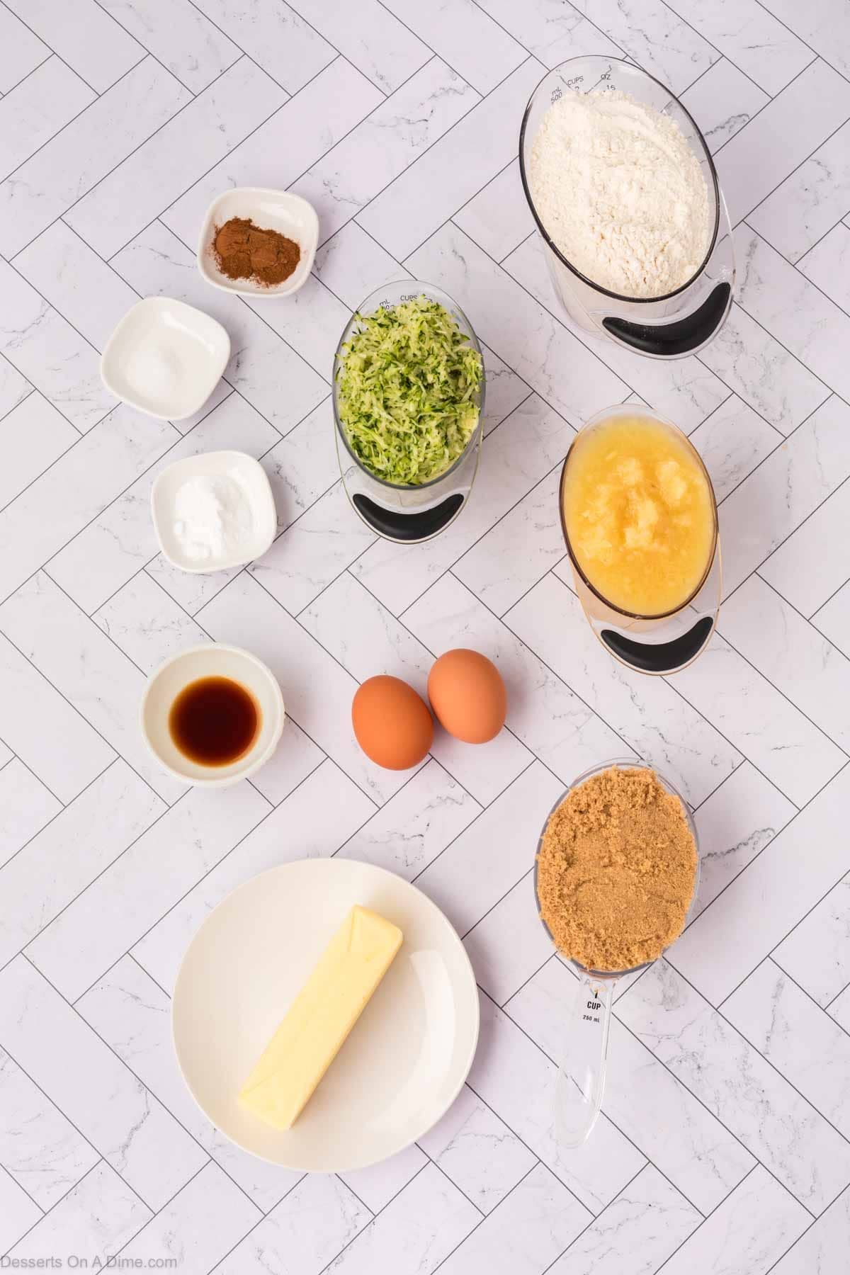 Ingredients for zucchini bread - brown sugar, butter, eggs, vanilla, zucchini, crushed pineapple, flour, baking soda, cinnamon. 