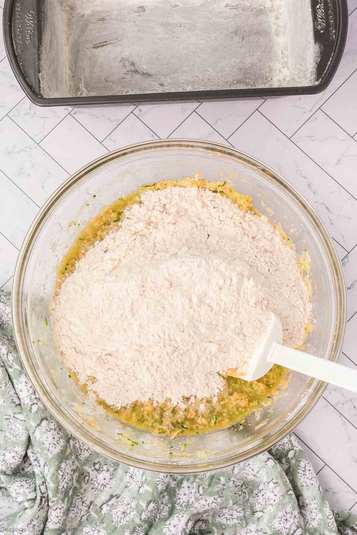 Wet and dry ingredients combined together in a bowl. 