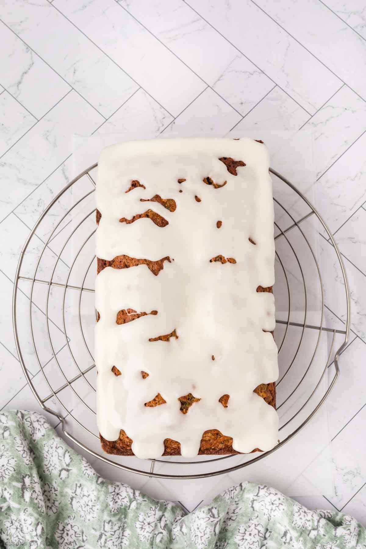 Bread on wire rack topped with glaze. 