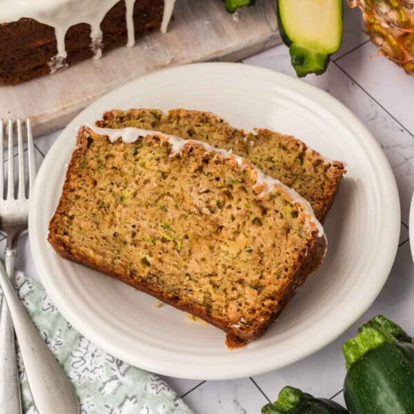 Slices of zucchini bread on a white plate.