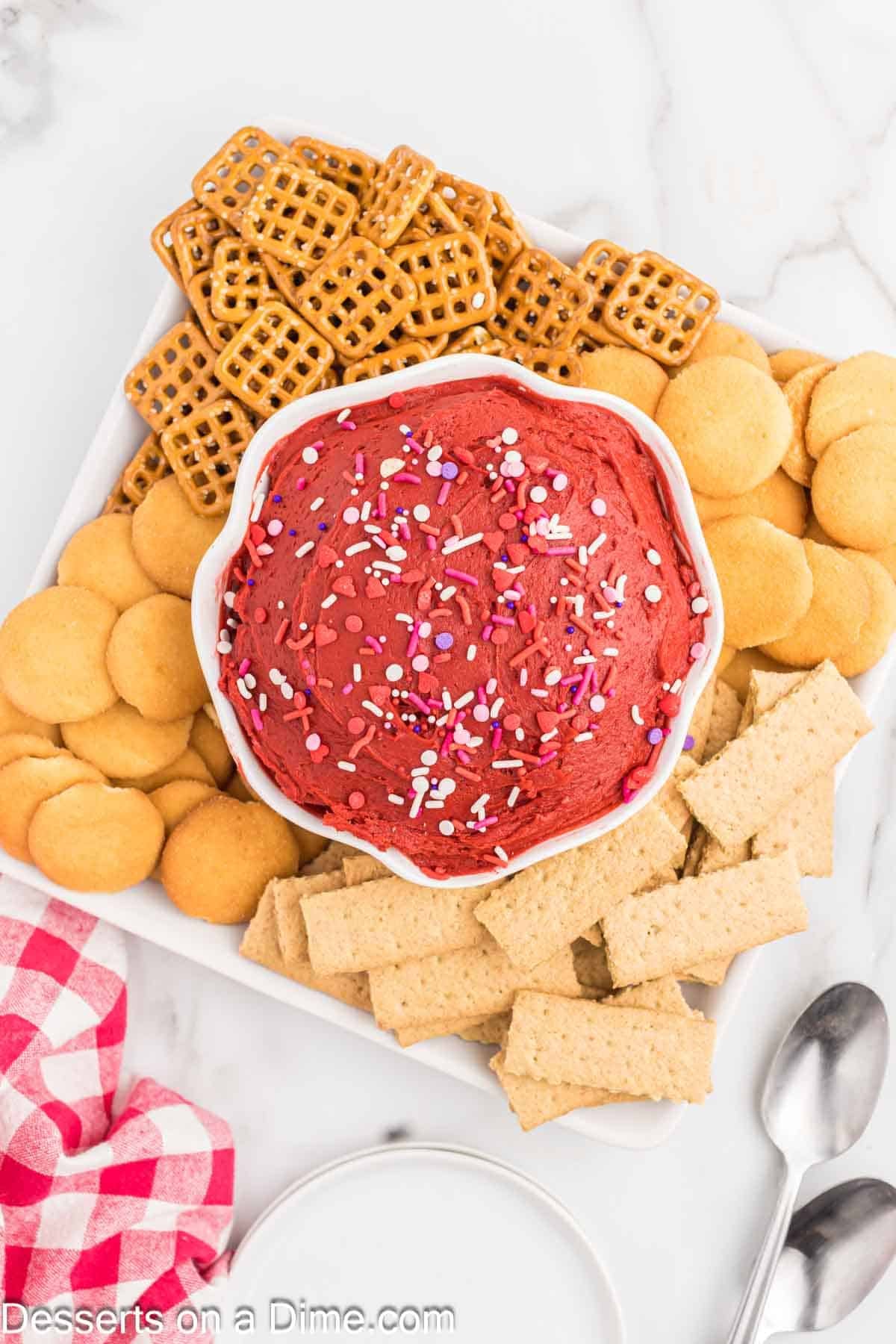 Red velvet dip in a bowl with dippers. 
