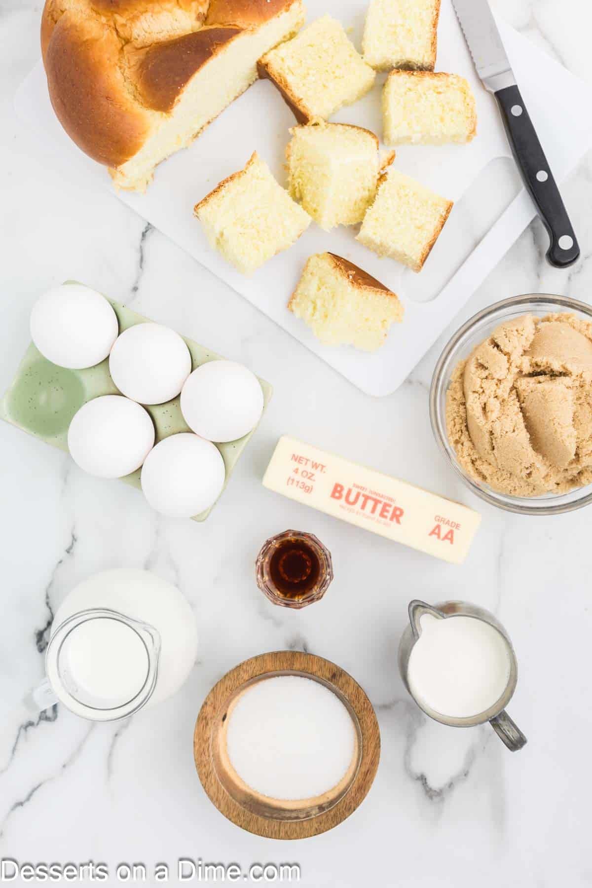 Ingredients for caramel bread pudding - challah bread, half and half, large eggs, vanilla extract, unsalted butter, brown sguar, sugar, brown sugar, heavy cream. 